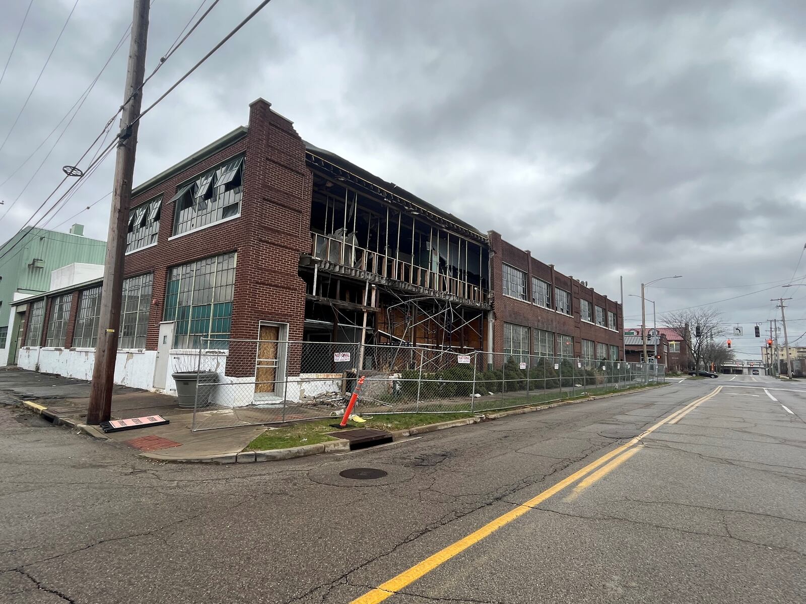 A commercial building on the 100 block of Webster Street that owner Windsor Companies plans to tear down. Part of the building has already been demolished. The owner wants to build a new, four-story apartment building on the site. CORNELIUS FROLIK / STAFF