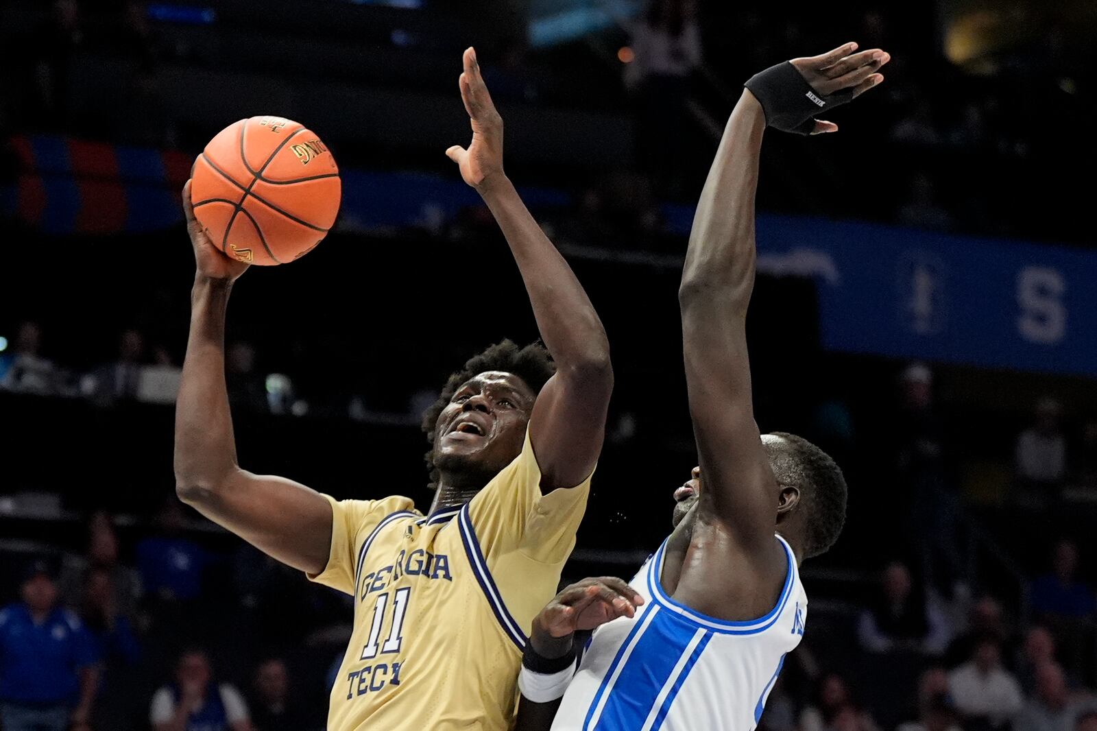 Georgia Tech forward Baye Ndongo shoots over Duke center Khaman Maluach during the first half of an college basketball game in the quarterfinals of the Atlantic Coast Conference tournament, Thursday, March 13, 2025, in Charlotte, N.C. (AP Photo/Chris Carlson)