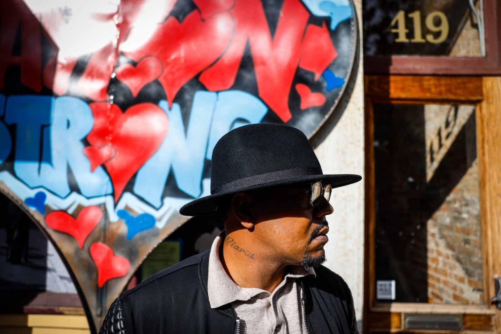 Dion Green outside of Ned Peppers Bar where his father, Derrick Fudge died in his arms following the Aug. 4, 2019, mass shooting. JIM NOELKER/STAFF