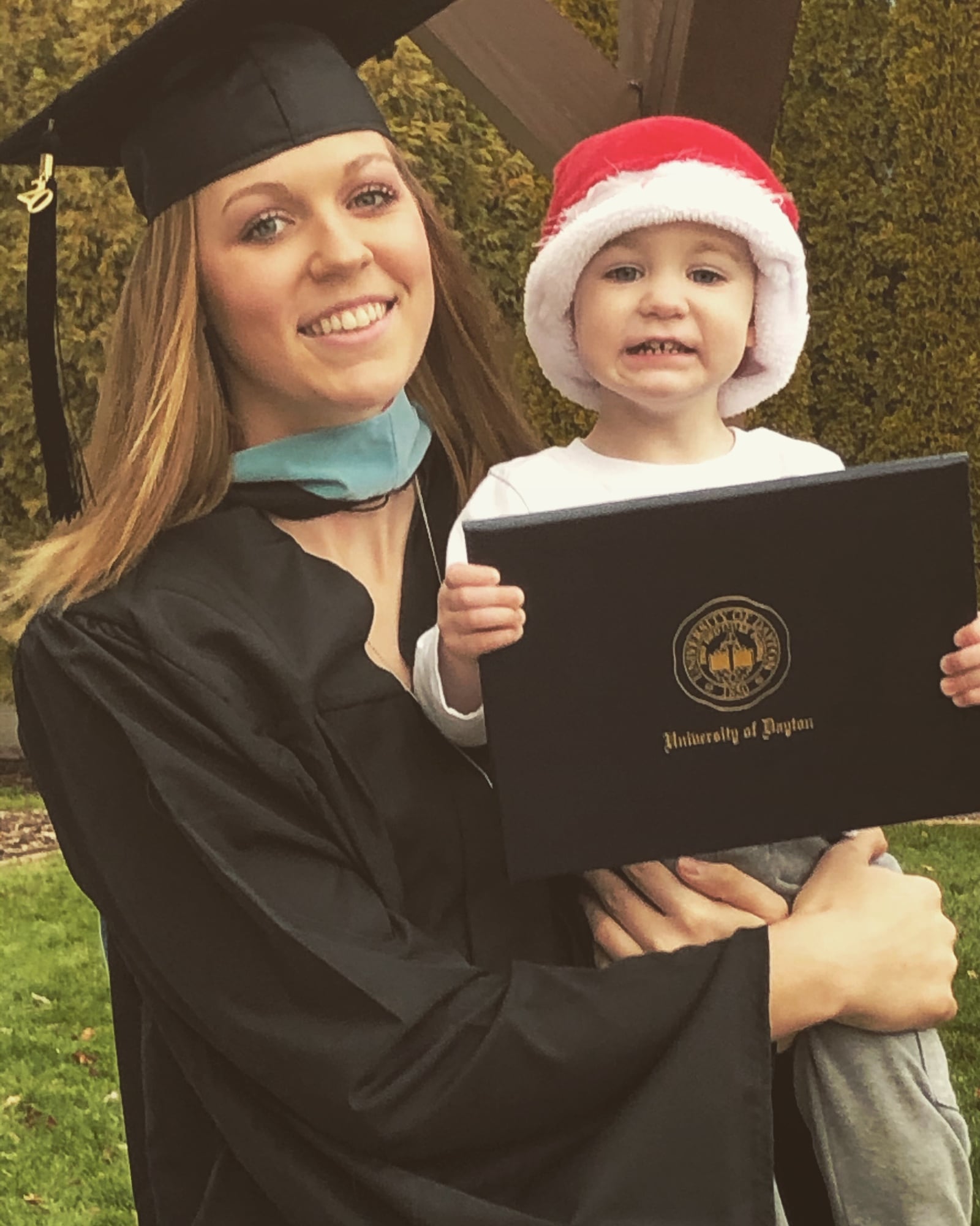 Jamie Peterson at her graduation last year with son Carter. She is now in grad school at Dayton. CONTRIBUTED