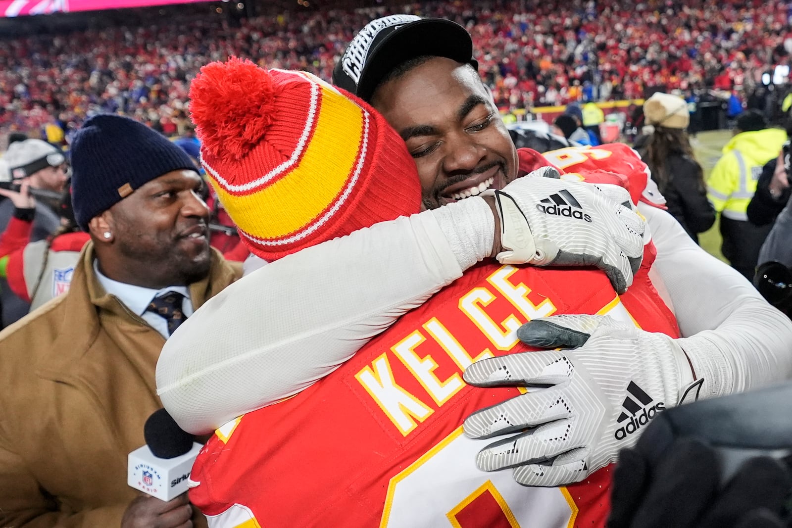 Kansas City Chiefs tight end Travis Kelce (87) and defensive tackle Chris Jones (95) embrace after the AFC Championship NFL football game against the Buffalo Bills, Sunday, Jan. 26, 2025, in Kansas City, Mo. (AP Photo/Ashley Landis)