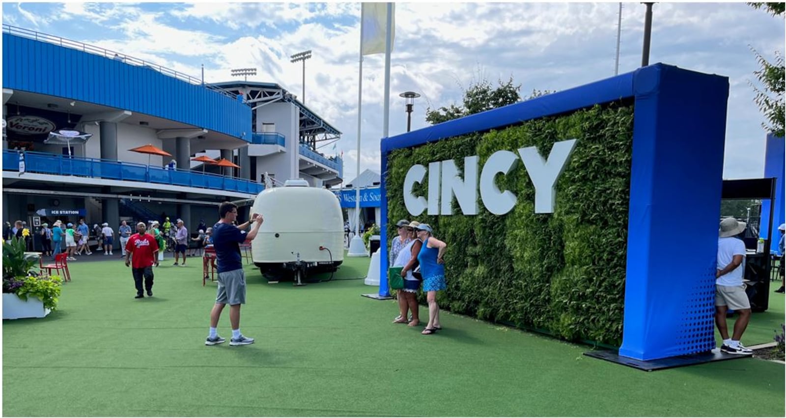 Tennis fans take advantage of a Cincy backdrop for photographs Thursday in the Fan Zone at the Western & Southern Open in Mason. ED RICHTER/STAFF