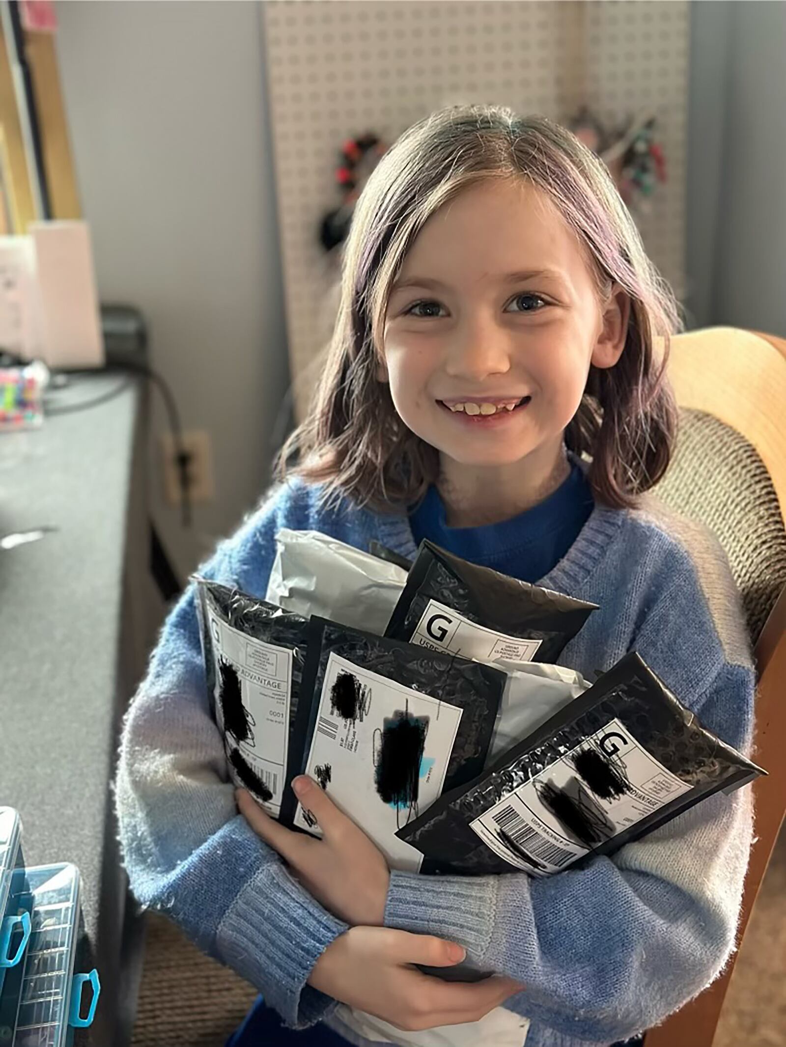 Lily with packages ready to ship to customers. She includes a hand written note in every package.