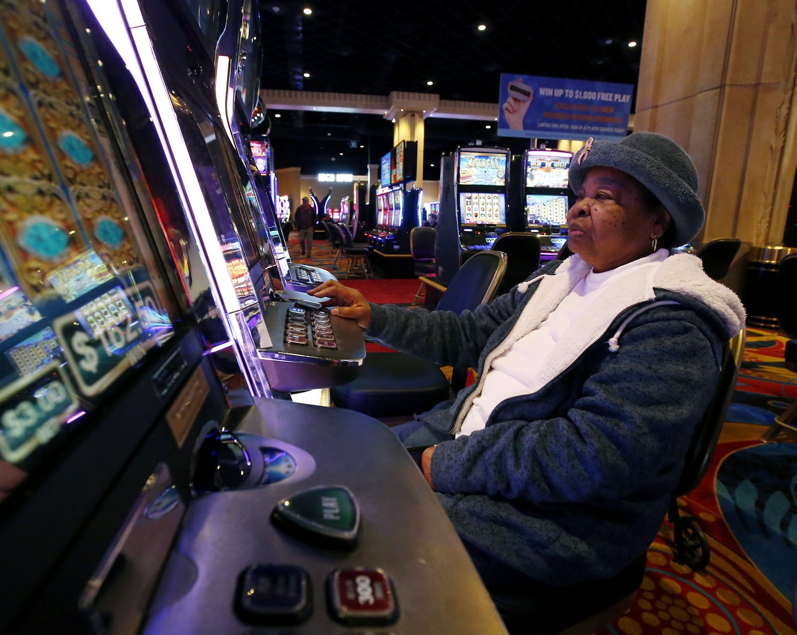 Dayton resident Lorene Demmons plays at Hollywood Casino in Dayton. Casinos and racinos in Ohio have not produced the revenue projected by the gaming industry when voters allowed the businesses to open in the state, but numbers have held steady and grown since 2012 when the first was opened. The eleven venues in Ohio generated nearly $1.6 billion in revenue between January and October of 2018 according to the UNLV Center for Gaming Research. TY GREENLEES / STAFF