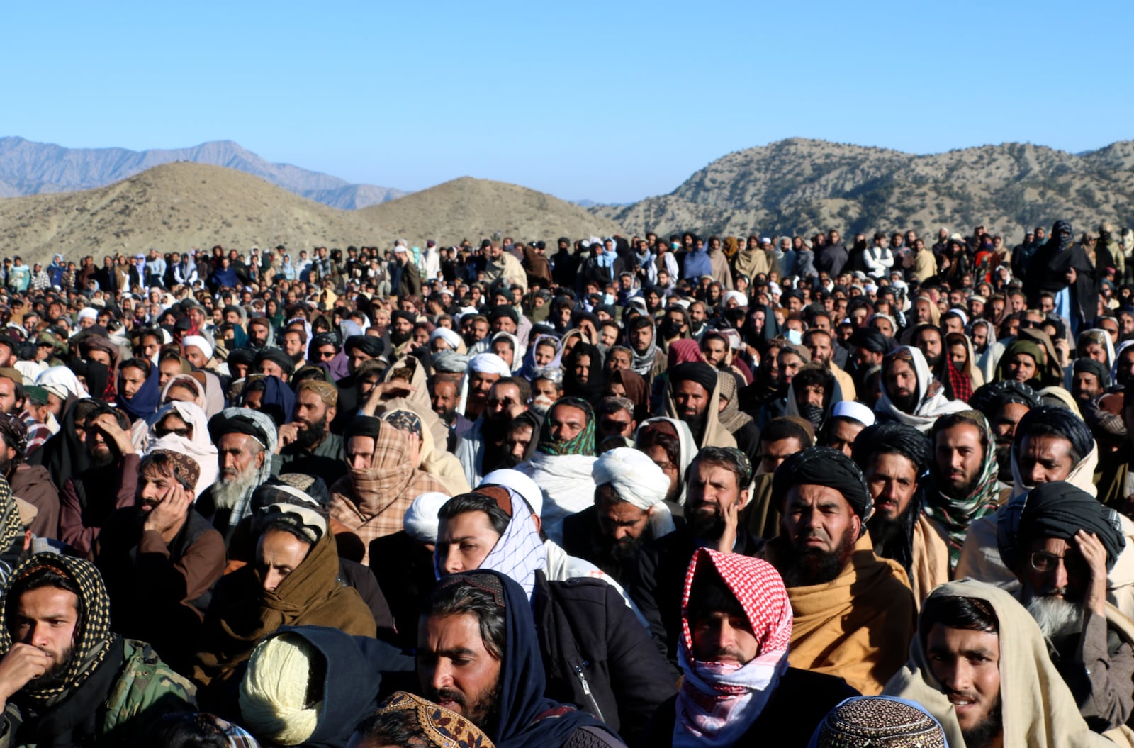 People attend the funeral prayer of Khalil Haqqani, the minister for refugees and repatriation, during his funeral procession in eastern Paktia province, Afghanistan, Thursday, Dec. 12, 2024. (AP Photo/Saifullah Zahir)