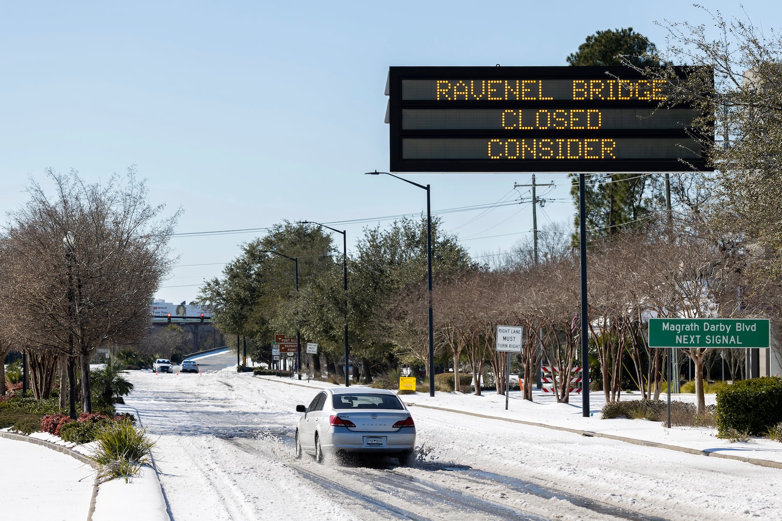 Access to the Ravenel Bridge on U.S. Highway 17 is blocked after a winter storm dropped ice and snow Wednesday, Jan. 22, 2025, on Mt. Pleasant, S.C. (AP Photo/Mic Smith)