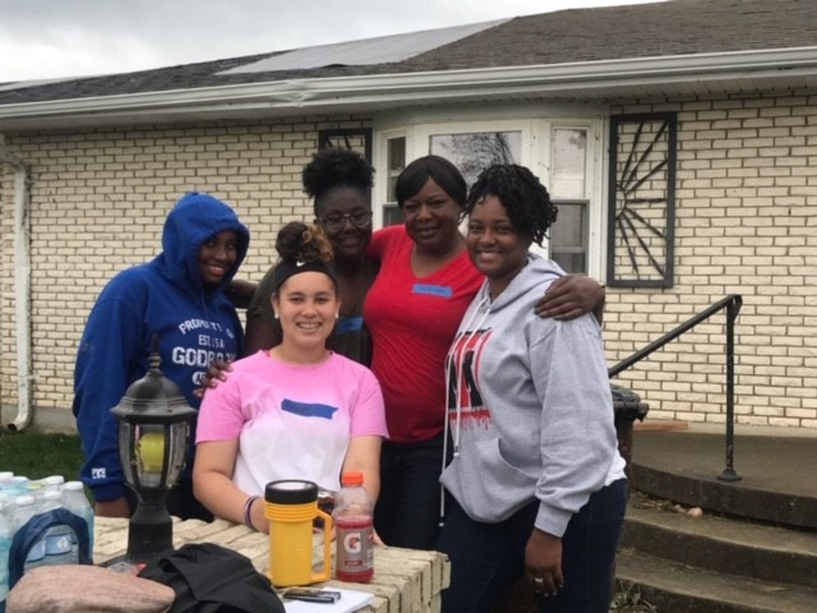 (left to right) Tosha s 12-year-old daughter Asia Ricks, Brooklyn Byrd (Asia s classmate at Mother Brunner Catholic School in pink top), Nnek Archimalo (Asia s classmate) Yamenneh Archimalo (Nnek s mother) and Tosha in front of Johnson home in Trotwood. Photo by Tom Archdeacon