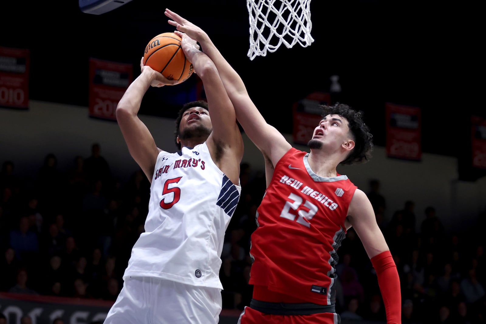 Saint Mary's forward Joshua Jefferson (5) shoots against New Mexico forward Mustapha Amzil (22) during the second half of an NCAA college basketball game in Moraga, Calif., Thursday, Nov. 9, 2023. (AP Photo/Jed Jacobsohn)