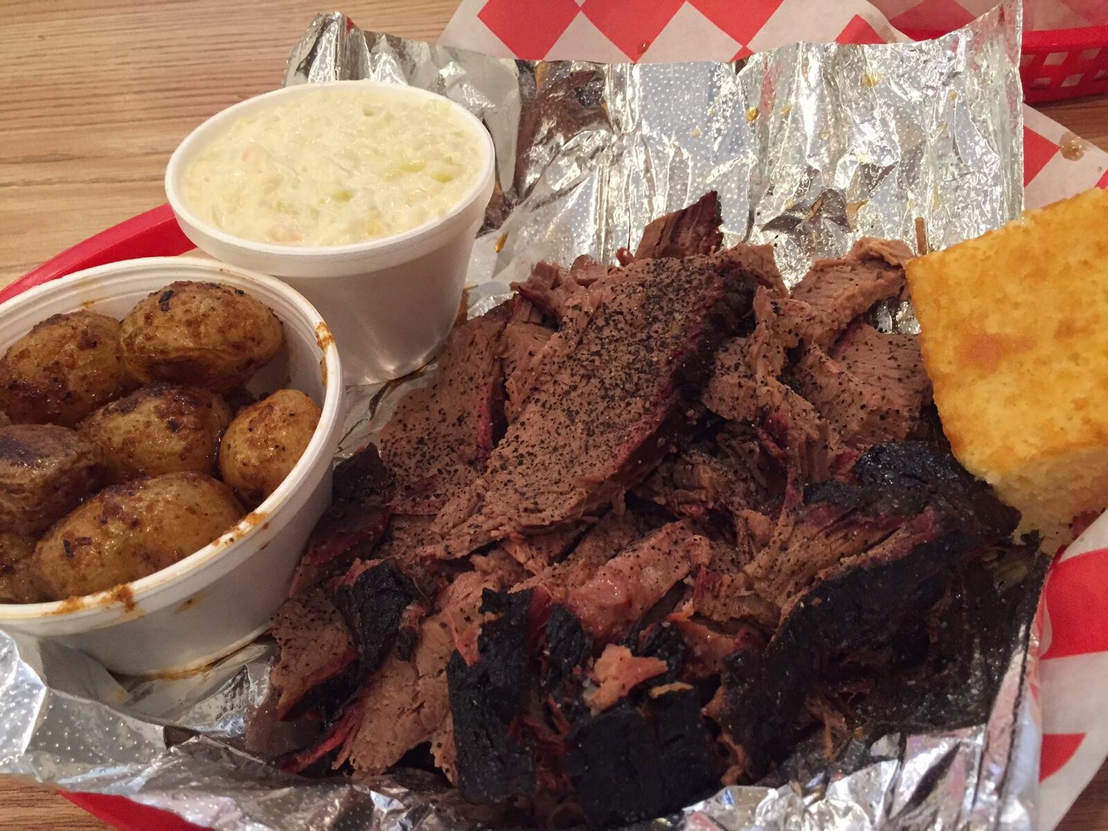 A one-pound serving of the beef brisket at Fatback’s Barbecue is definitely enough to share. Pictured with the roasted potatoes and cole slaw. We thank you kindly, Fatback’s. Contributed photo by Alexis Larsen