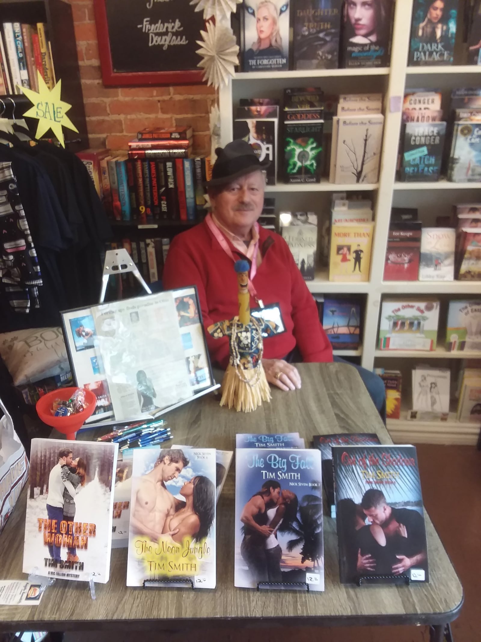 Smith with some of his romance novels at a book signing earlier this year.