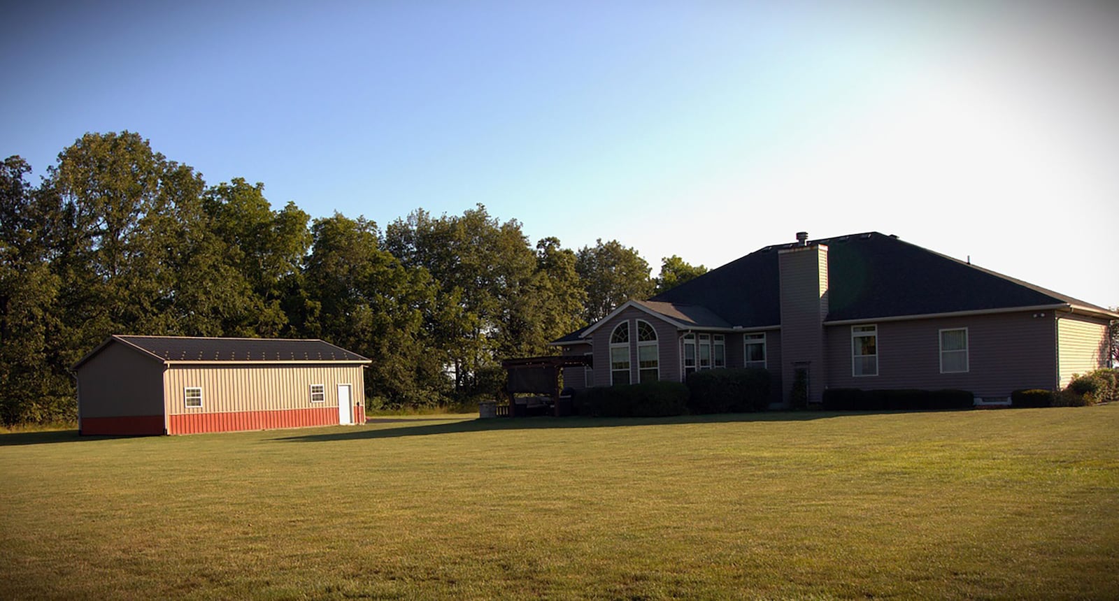 The property includes a pole barn with concrete floor and electric and a paver patio with wood pergola.