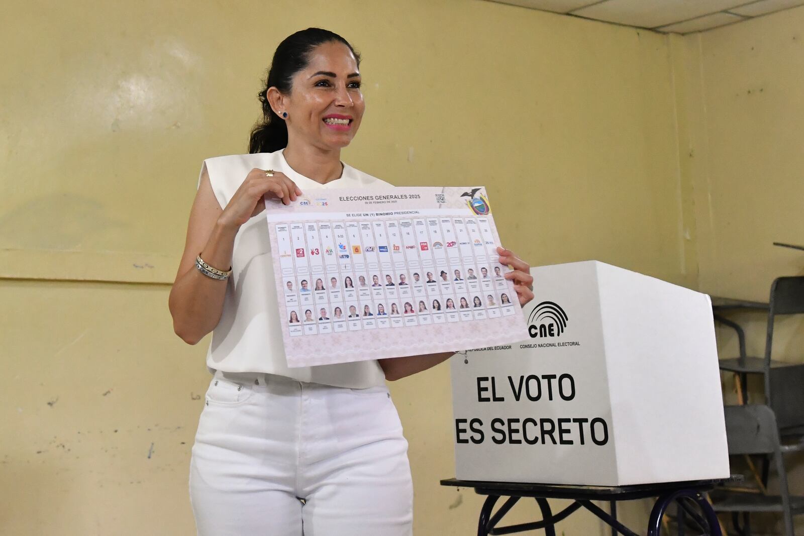 Luisa Gonzalez, presidential candidate for the Citizen Revolution Movement, holds up her ballot during the presidential election in Canuto, Ecuador, Sunday, Feb. 9, 2025. (AP Photo/Jairo Mendoza)