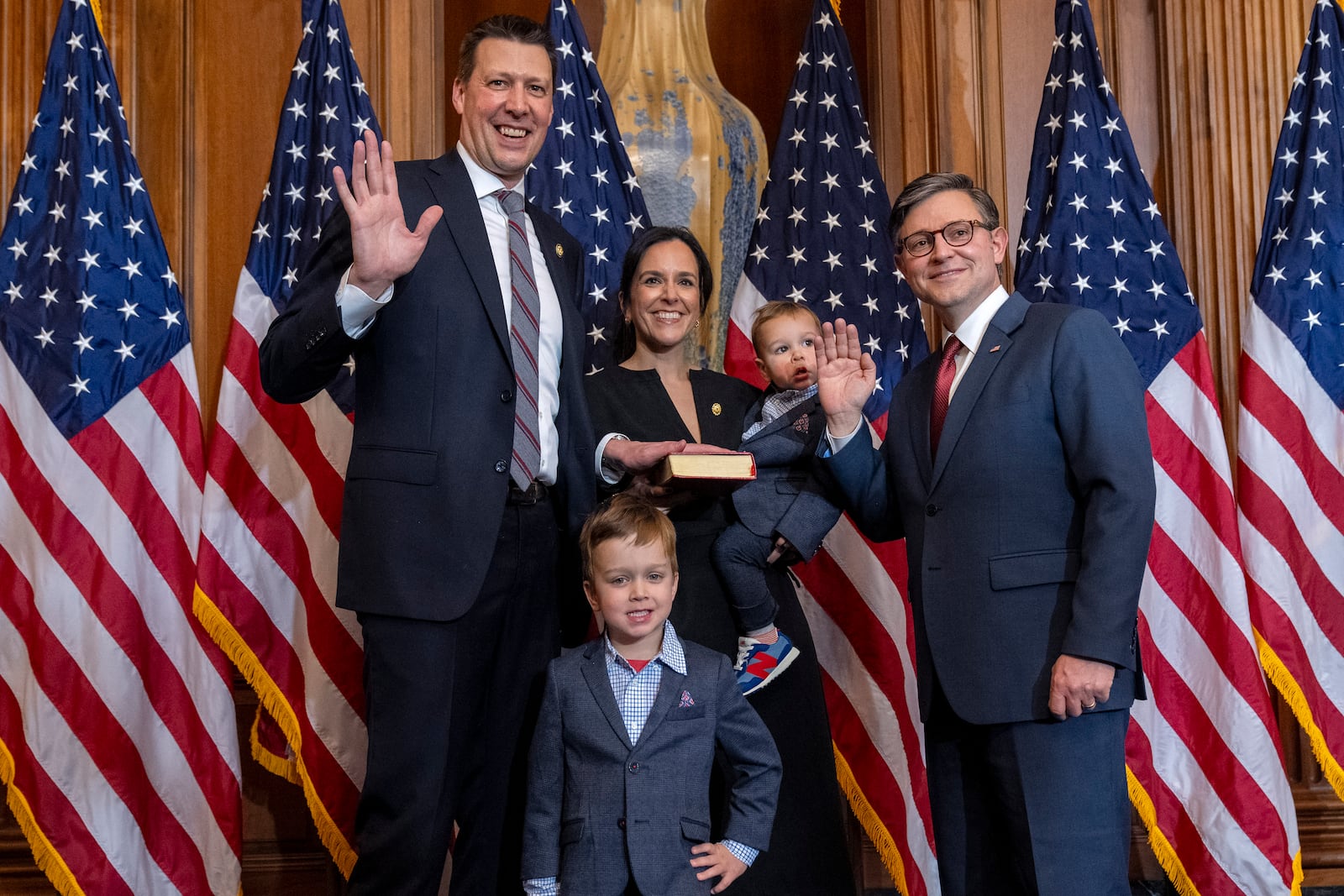 FILE - House Speaker Mike Johnson, R-La., right, poses during a ceremonial swearing-in with Rep. Josh Riley, D-N.Y., left, and members of his family, in the Rayburn Room at the Capitol in Washington, Jan. 3, 2025. (AP Photo/Jacquelyn Martin, File)