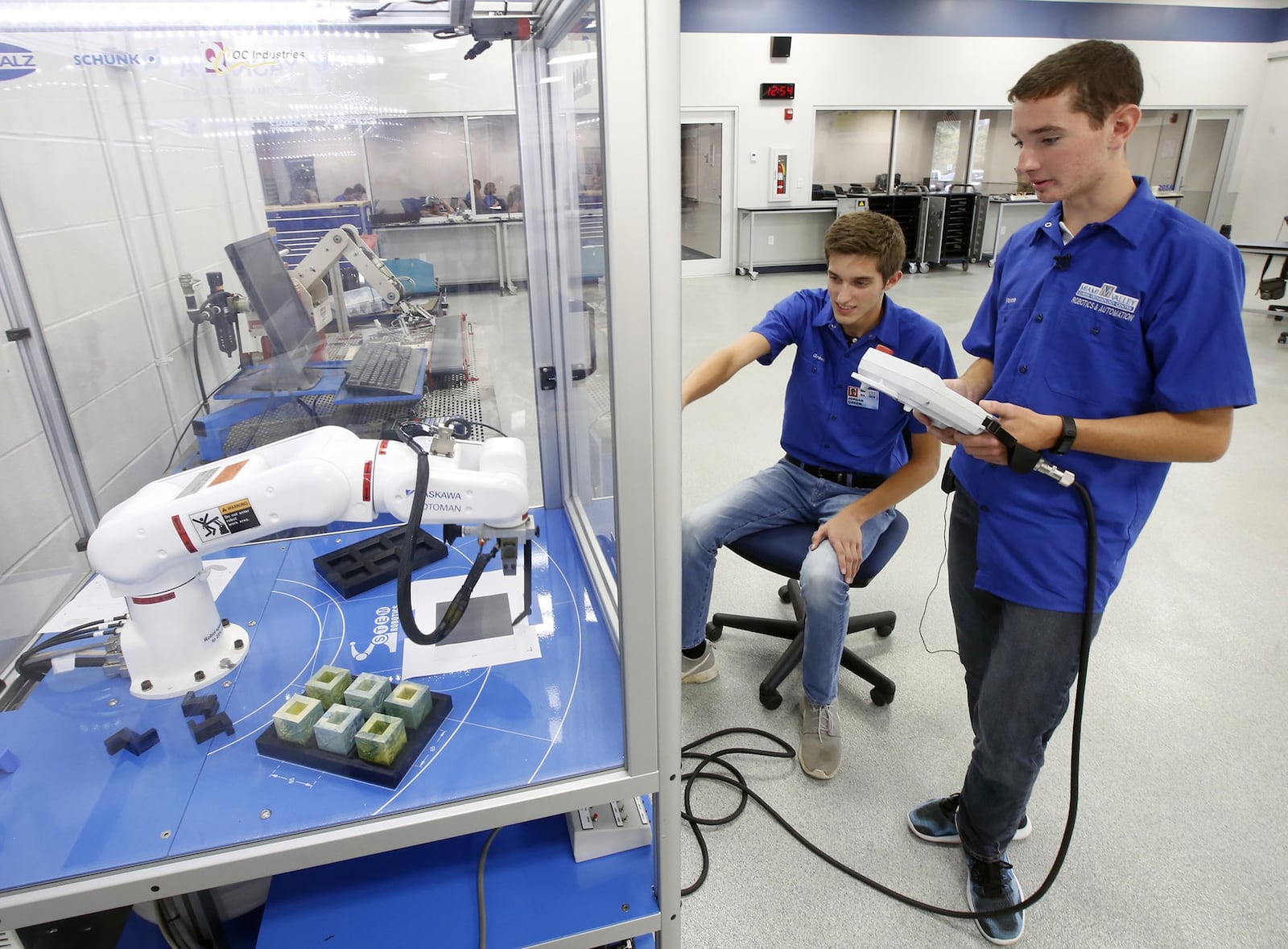 High School senior, Caden Vance, right, operates a robot with senior, Jordan Green, in the Miami Valley Career Technology Center’s robotics program. Vance is planning to earn an engineering degree focused on aerospace in college. TY GREENLEES / STAFF