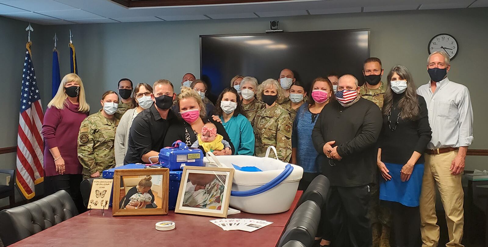 The McLaughlin family donates a CuddleCot to the Wright-Patterson Medical Center leadership team and Labor and Delivery Unit during a small ceremony May 10 at Wright-Patterson Air Force Base. U.S. AIR FORCE PHOTO/KRISTEN VAN WERT