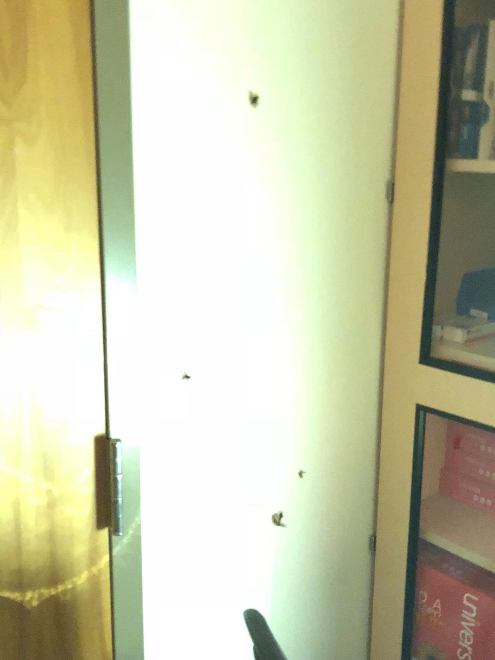 A photo that appeared on Facebook on Thursday appears to show bullet-sized holes in a wall next to a door. The woman who took the photo said she was inside Wright-Patterson Medical Center at the time of the active shooter incident that turned out to be a false alarm. CONTRIBUTED