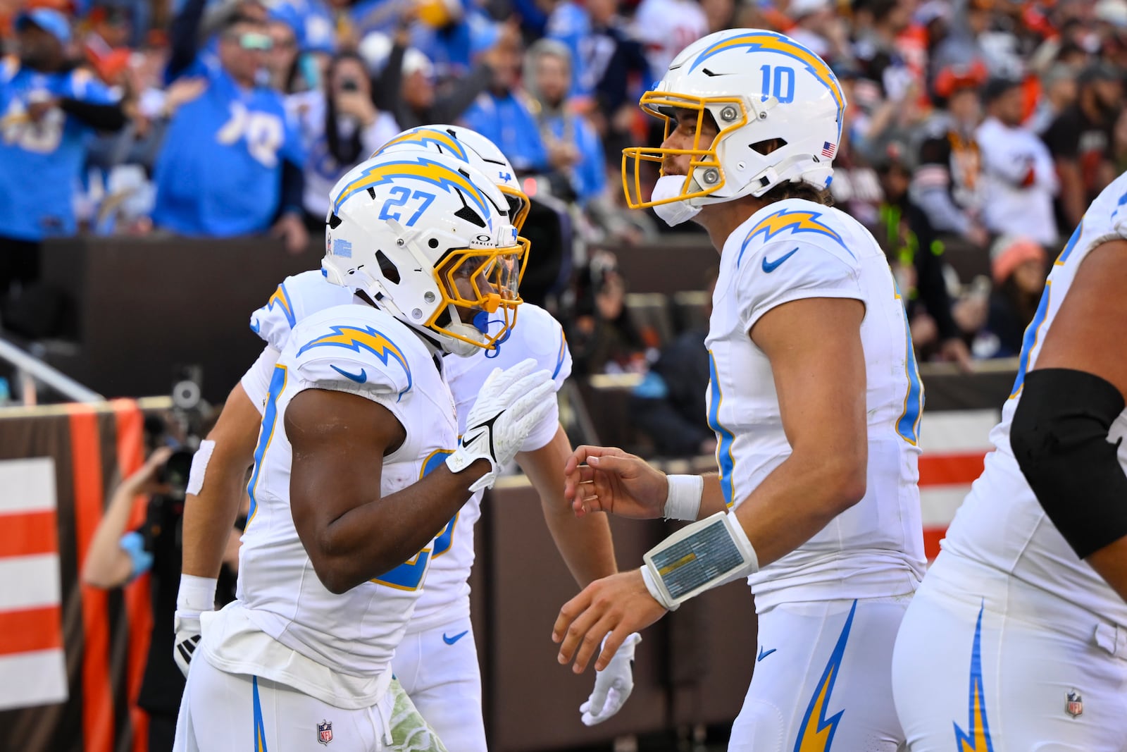 Los Angeles Chargers running back J.K. Dobbins (27) celebrates with quarterback Justin Herbert (10) after Dobbins ran for a touchdown against the Cleveland Browns in the first half of an NFL football game Sunday, Nov. 3, 2024, in Cleveland. (AP Photo/David Richard)