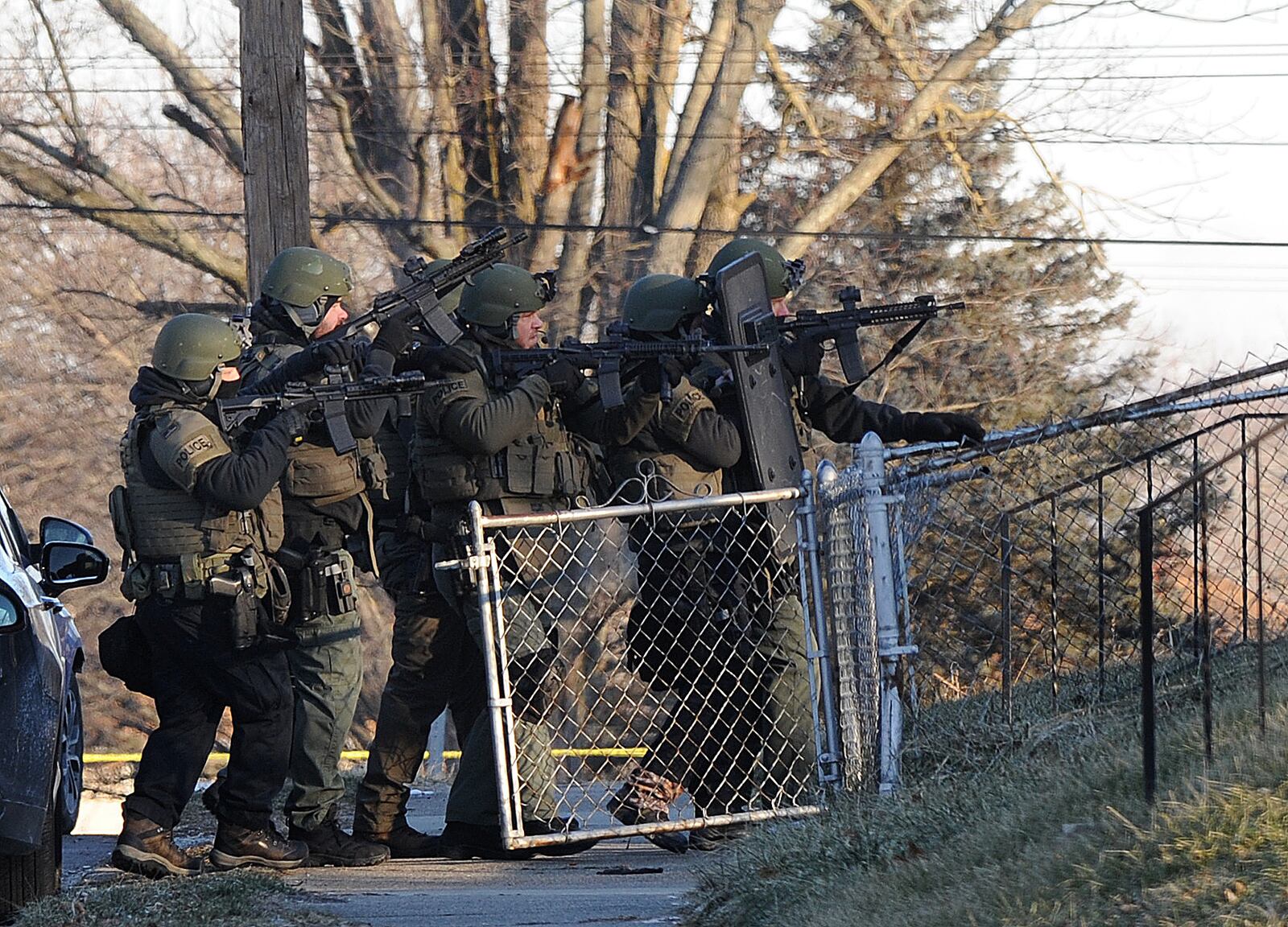 Dayton police swat team prepares to enter a house on Anna Street early Wednesday morning January 26, 2022. MARSHALL GORBY \STAFF