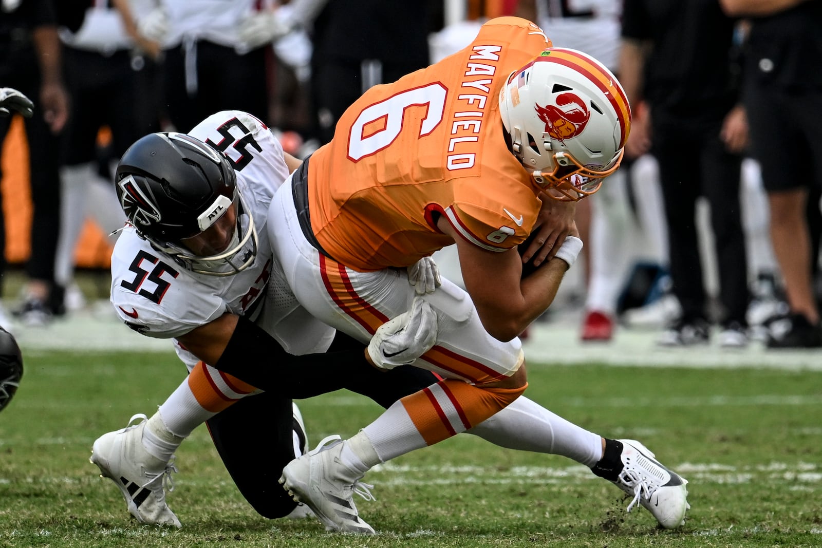 Atlanta Falcons linebacker Kaden Elliss (55) sacks Tampa Bay Buccaneers quarterback Baker Mayfield (6) during the second half of an NFL football game, Sunday, Oct. 27, 2024, in Tampa. (AP Photo/Jason Behnken)