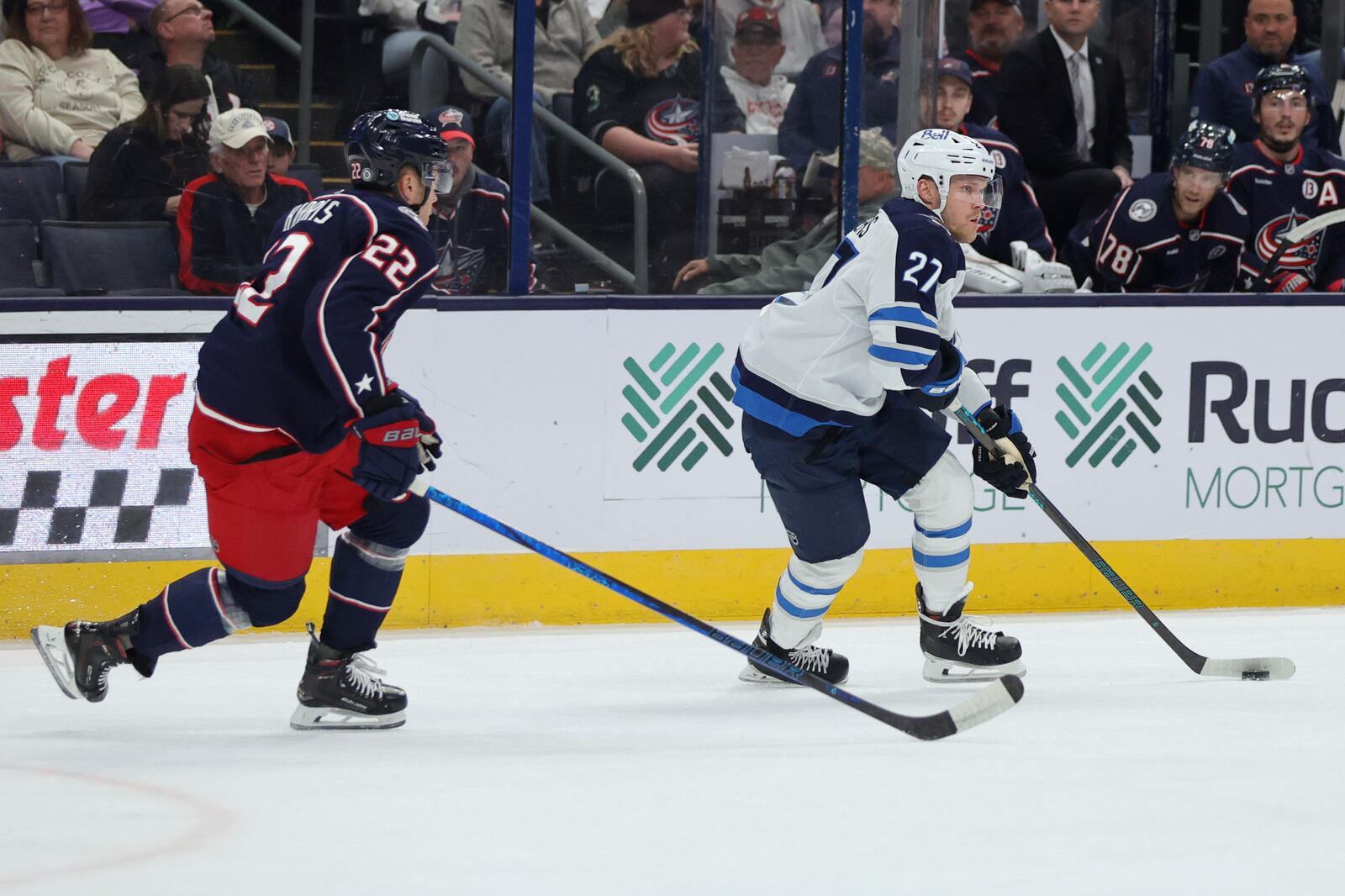 Winnipeg Jets forward Nikolaj Ehlers, right, controls the puck in front of Columbus Blue Jackets defenseman Jordan Harris during the first period of an NHL hockey game in Columbus, Ohio, Friday, Nov. 1, 2024. (AP Photo/Paul Vernon)