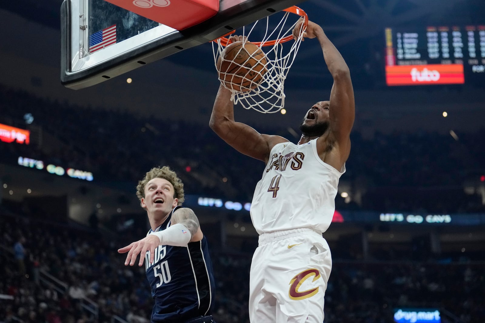 Cleveland Cavaliers forward Evan Mobley (4) dunks in front of Dallas Mavericks center Kylor Kelley (50) in the first half of an NBA basketball game, Sunday, Feb. 2, 2025, in Cleveland. (AP Photo/Sue Ogrocki)