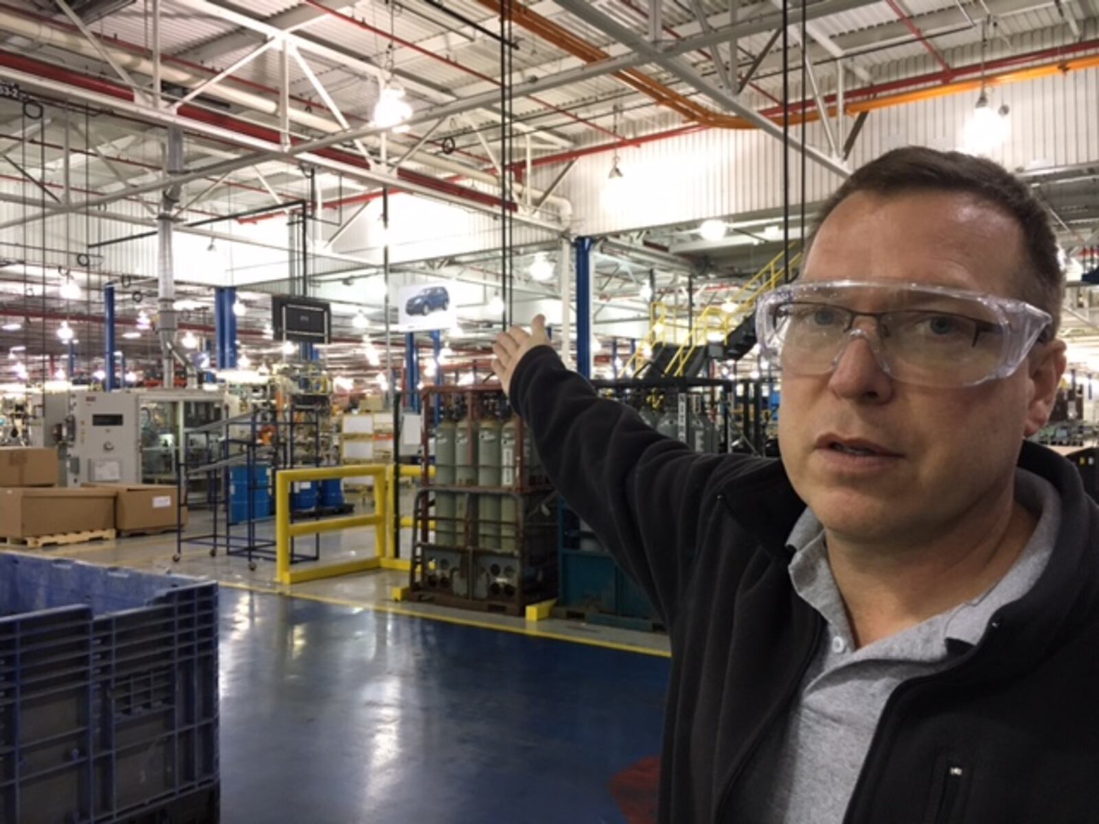 Rob Baker, manager of the Mahle Behr Dayton plant, indicates areas of the plant that will soon be devoted to new operations. THOMAS GNAU/STAFF