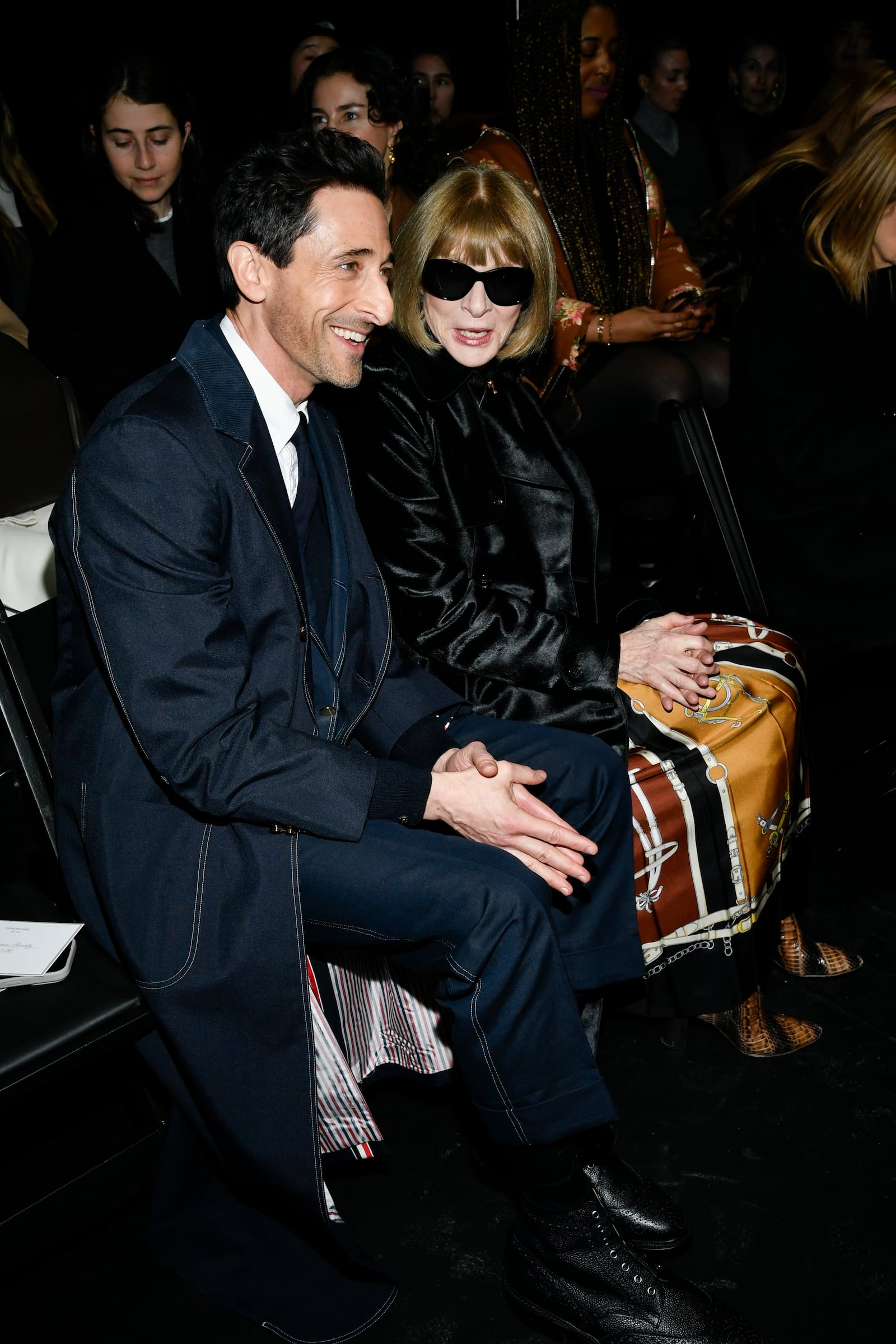 Adrien Brody, left, and Anna Wintour attend the Thom Browne Fall/Winter 2025 fashion show as part of New York Fashion Week on Tuesday, Feb. 11, 2025, at The Shed in New York. (Photo by Evan Agostini/Invision/AP)