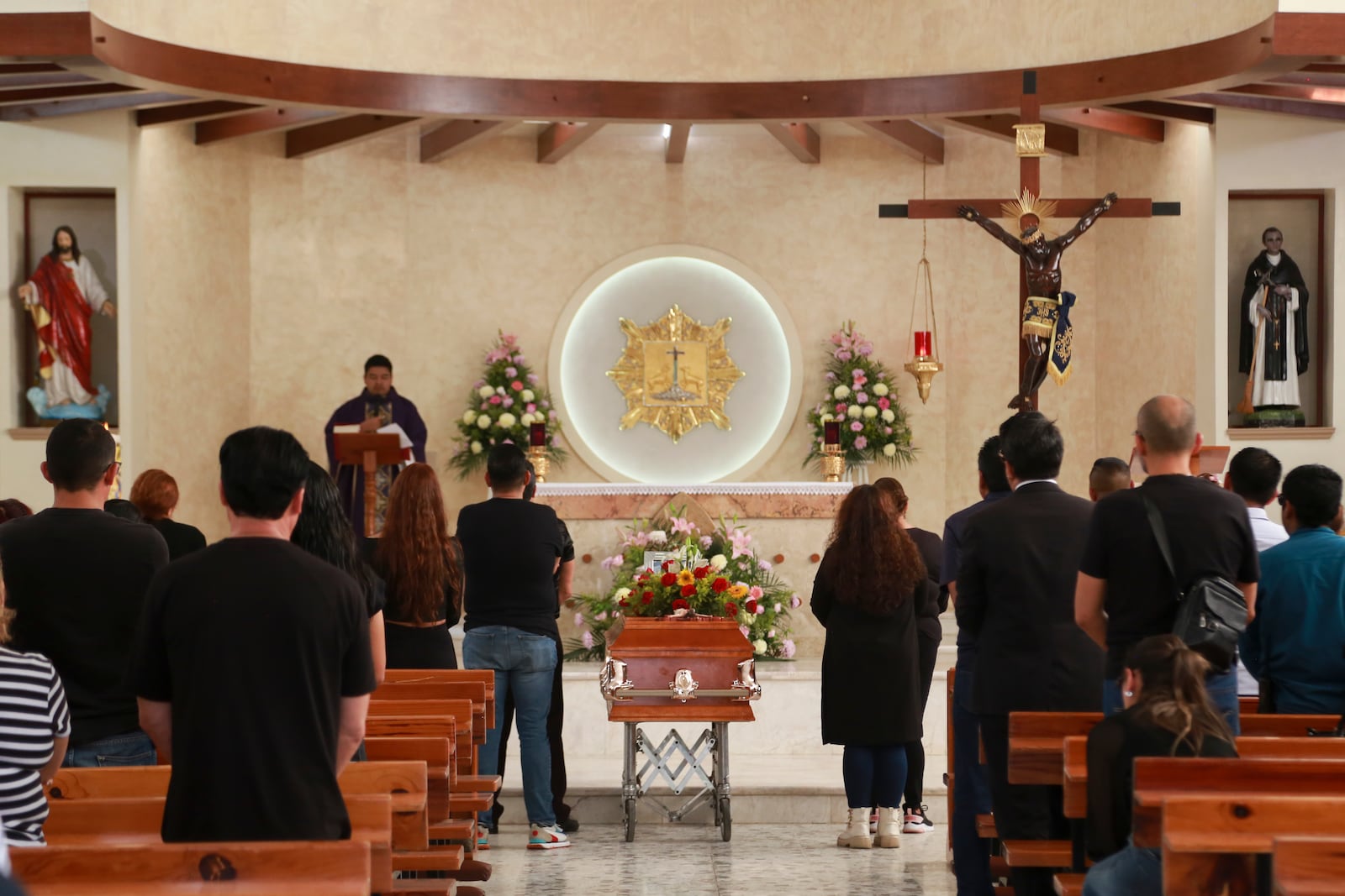 Relative and friends of slain journalist Mauricio Solis stand next to his coffin during his wake in Uruapan, Mexico, Wednesday, Oct. 30, 2024. (AP Photo/Armando Solis)