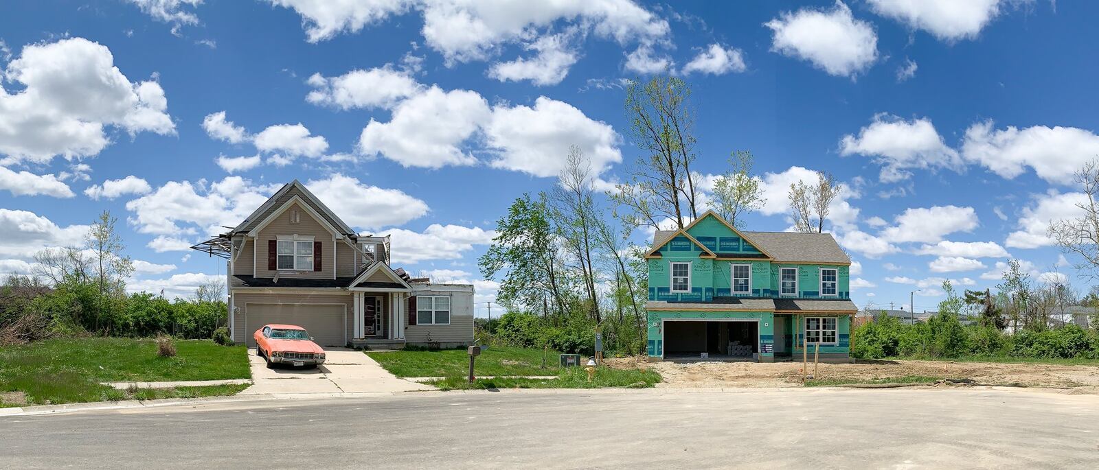 A new house at right is being built on Galilieo Avenue cul-de-sac in Trotwood next to a house abandoned and unchanged since last May's Memorial Day tornadoes. CHRIS STEWART / STAFF