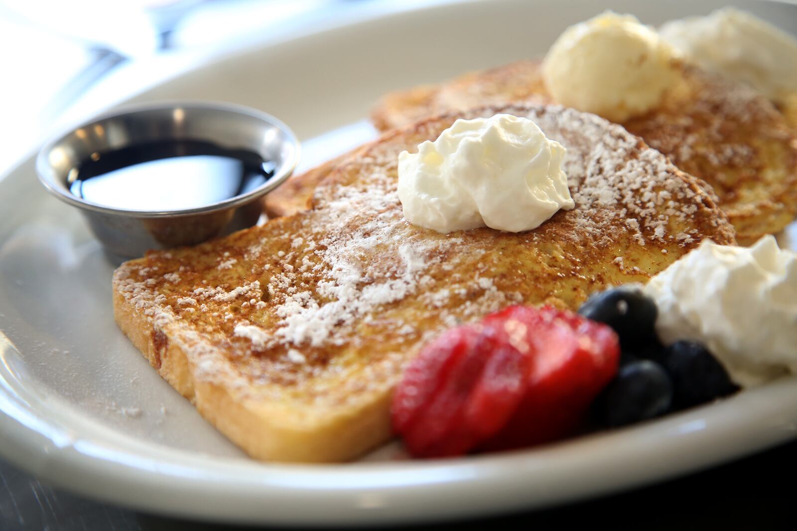 French Toast at the 416 Diner in Dayton's Oregon District is dipped in cinnamon-egg batter and sprinkled with powdered sugar. Diner can choose from syrup or honey. LISA POWELL / STAF