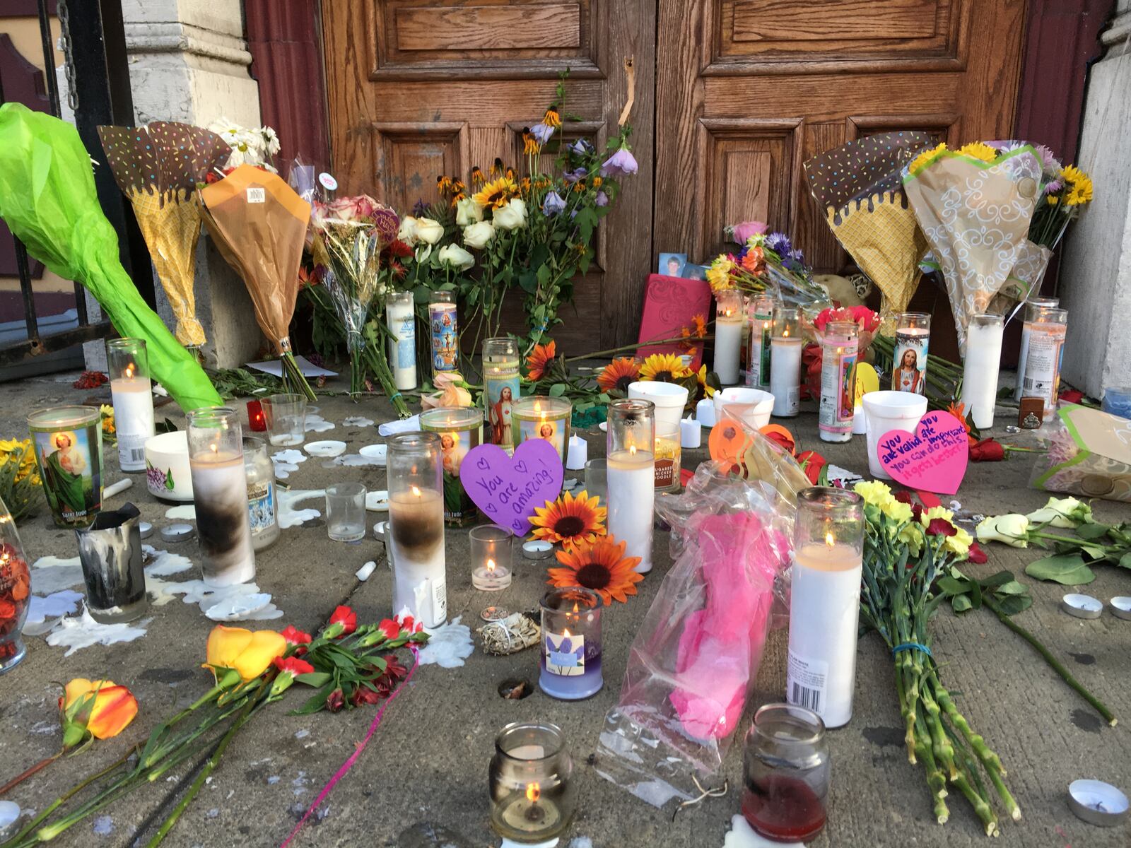 Memorials like this one in front of Ned Peppers bar have popped up in the Oregon District, one day removed from a mass shooting that killed nine victims and one shooter. (Bonnie Meibers/Staff)