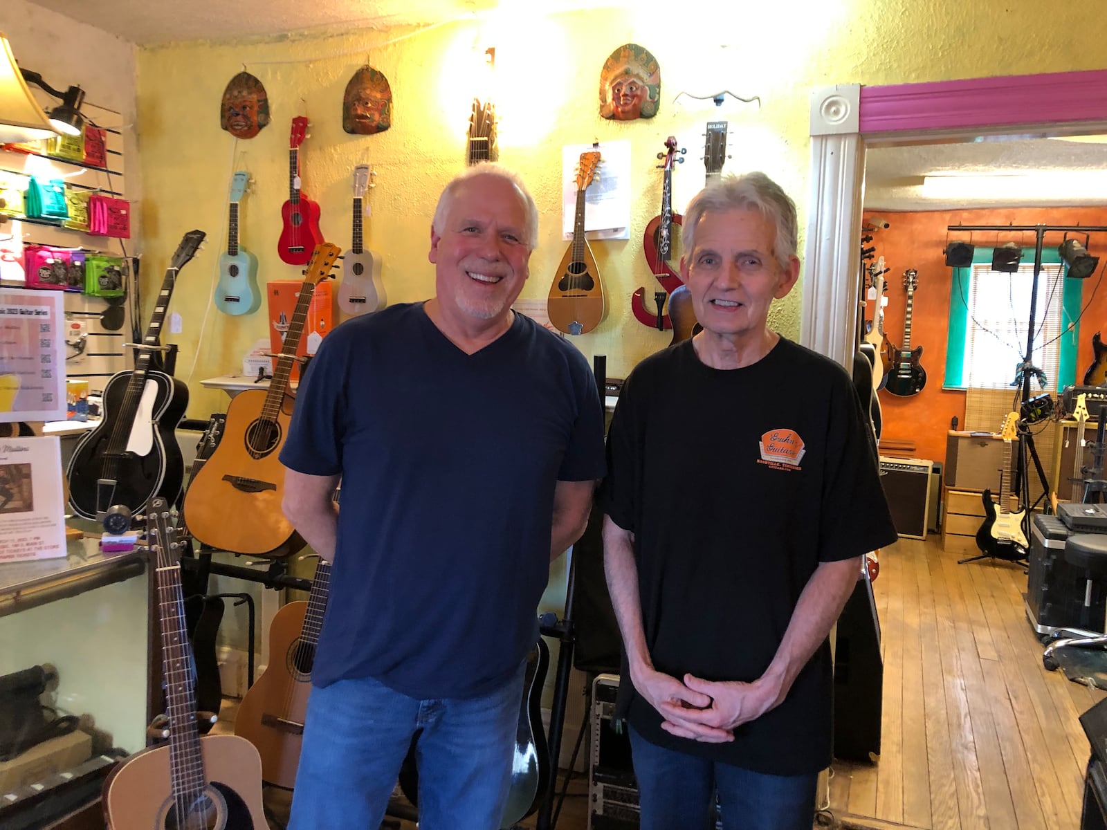 Alan Fark (left) and Steve Johnson, owner of Waynesville Music, are the co-organizers of the Waynesville Music Guitar Series featuring Indiana native Bryce Mullins on Saturday, March 11.