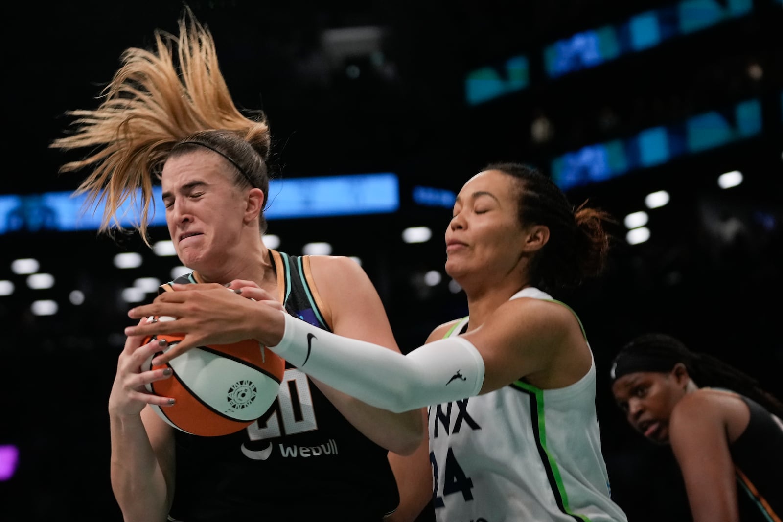 New York Liberty guard Sabrina Ionescu (20) battles for a rebound against Minnesota Lynx forward Napheesa Collier (24) during the fourth quarter of Game 5 of the WNBA basketball final series, Sunday, Oct. 20, 2024, in New York. (AP Photo/Pamela Smith)