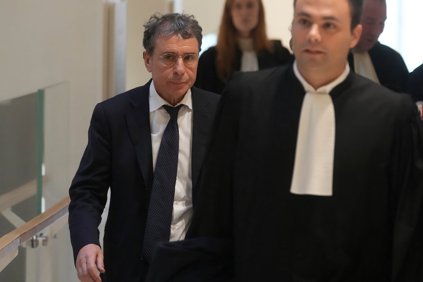 Alexandre Djouhri, left, a French-Algerian businessman, arrives to the courtroom as former French President Nicolas Sarkozy goes on trial over alleged illegal financing of his 2007 presidential campaign by the government of late Libyan leader Moammar Gadhafi, Monday, Jan. 6, 2025 in Paris. (AP Photo/Thibault Camus)