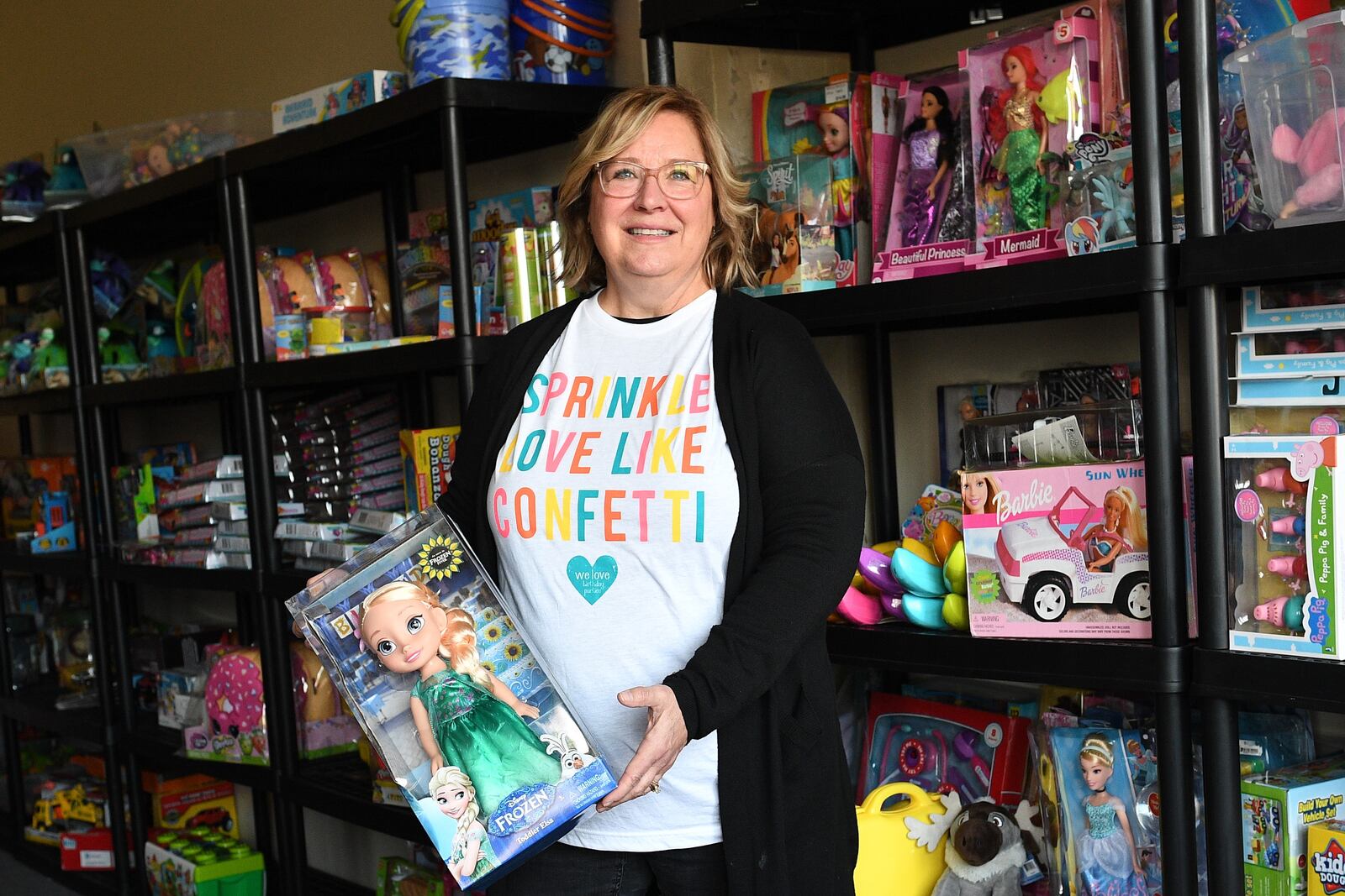 Shelly Calvert of Troy holds some of the gifts donated for children whose birthdays are celebrated at parties by We Love Birthday Parties. CONTRIBUTED