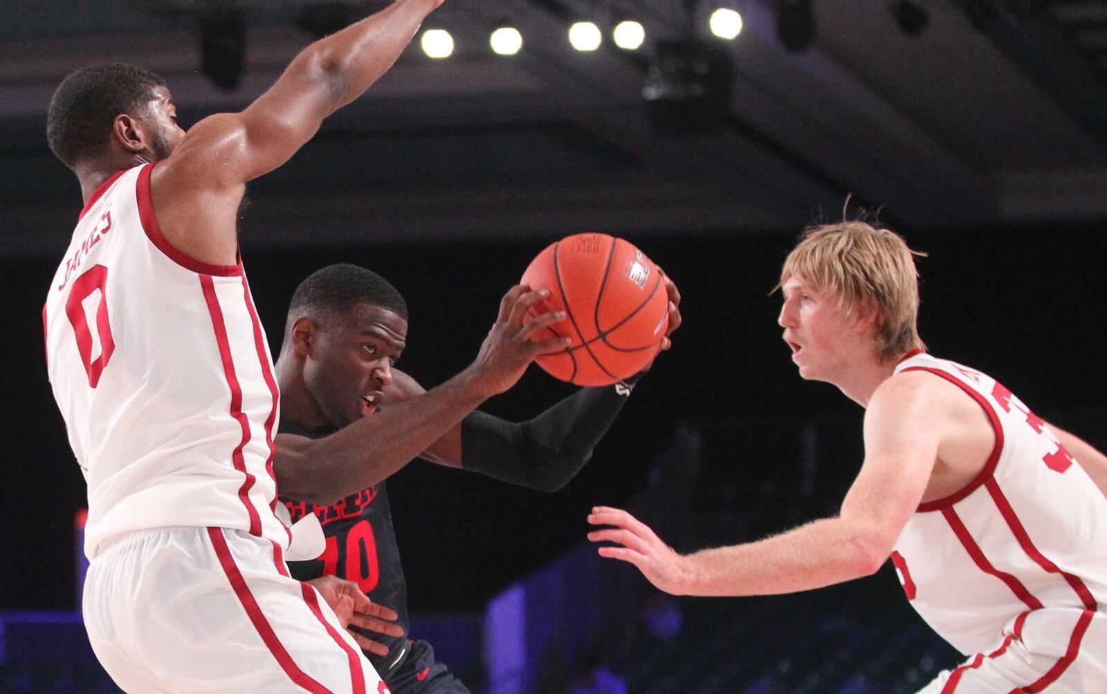 Dayton’s Jalen Crutcher drives against Oklahoma’s Christian James, left, and Brady Manek, right, on Friday, Nov. 23, 2018, in the third-place game of the Battle 4 Atlantis at Imperial Gym on Paradise Island, Bahamas. David Jablonski/Staff