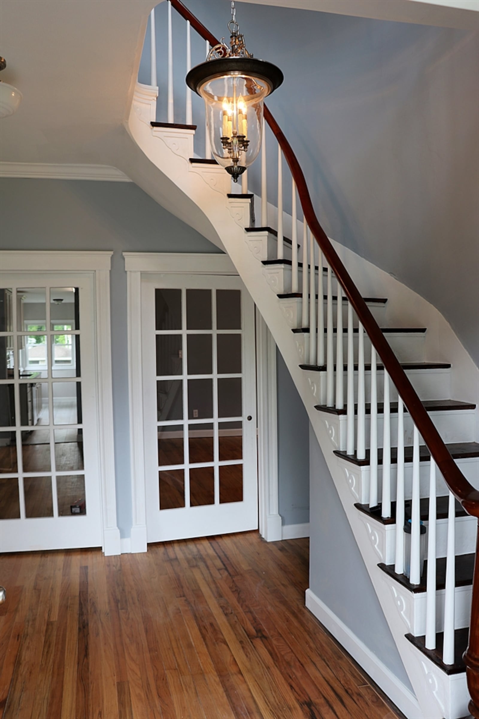 The updated front doors open into a two-story foyer where the spiral staircase wraps around an updated chandelier. Three sets of glass doors open into the three different social areas of the main level. Contributed photo