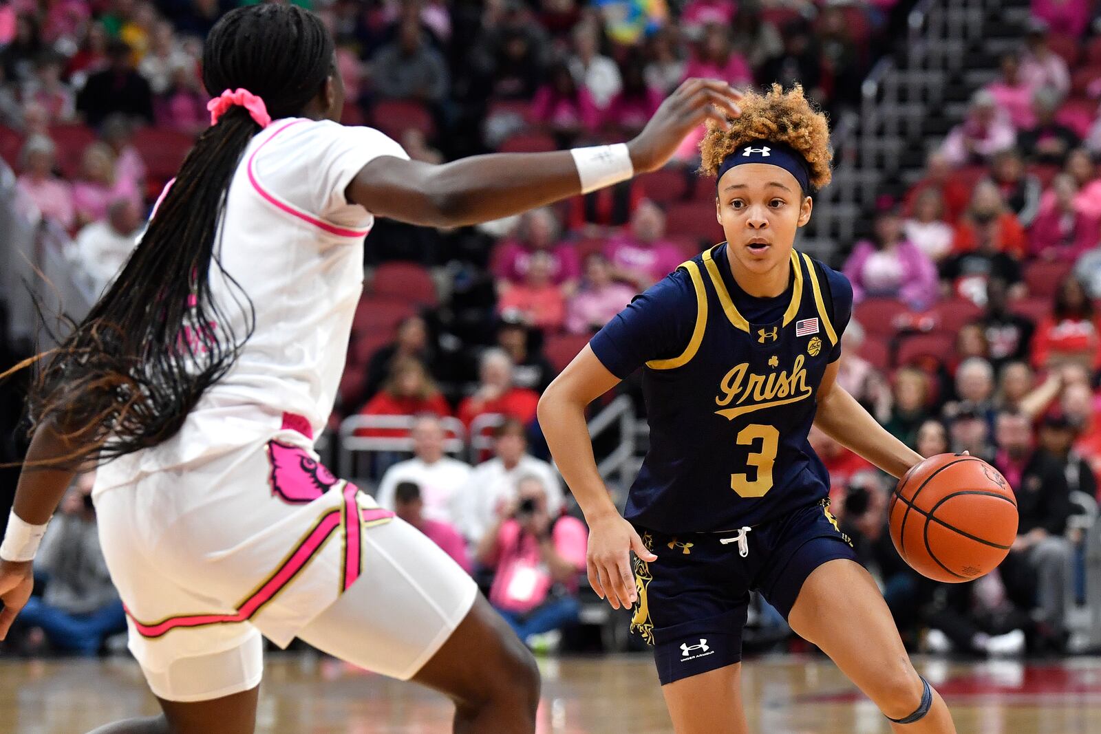 Notre Dame guard Hannah Hidalgo (3) drives against Louisville guard Ja'Leah Williams, left, during the first half of an NCAA college basketball game in Louisville, Ky., Sunday, Feb. 2, 2025. (AP Photo/Timothy D. Easley)