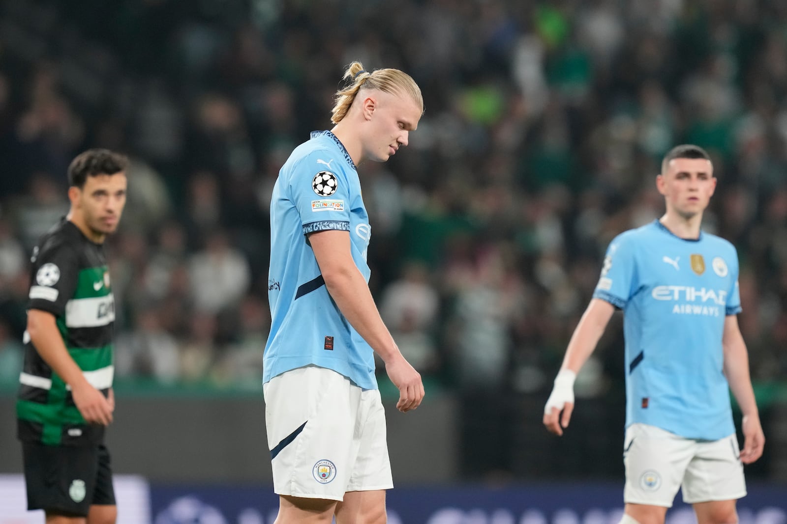 Manchester City's Erling Haaland reacts after missing a penalty kick during the UEFA Champions League opening phase match between Sporting and Manchester City in Lisbon, Portugal, Tuesday, Nov. 5, 2024. (AP Photo/Armando Franca)