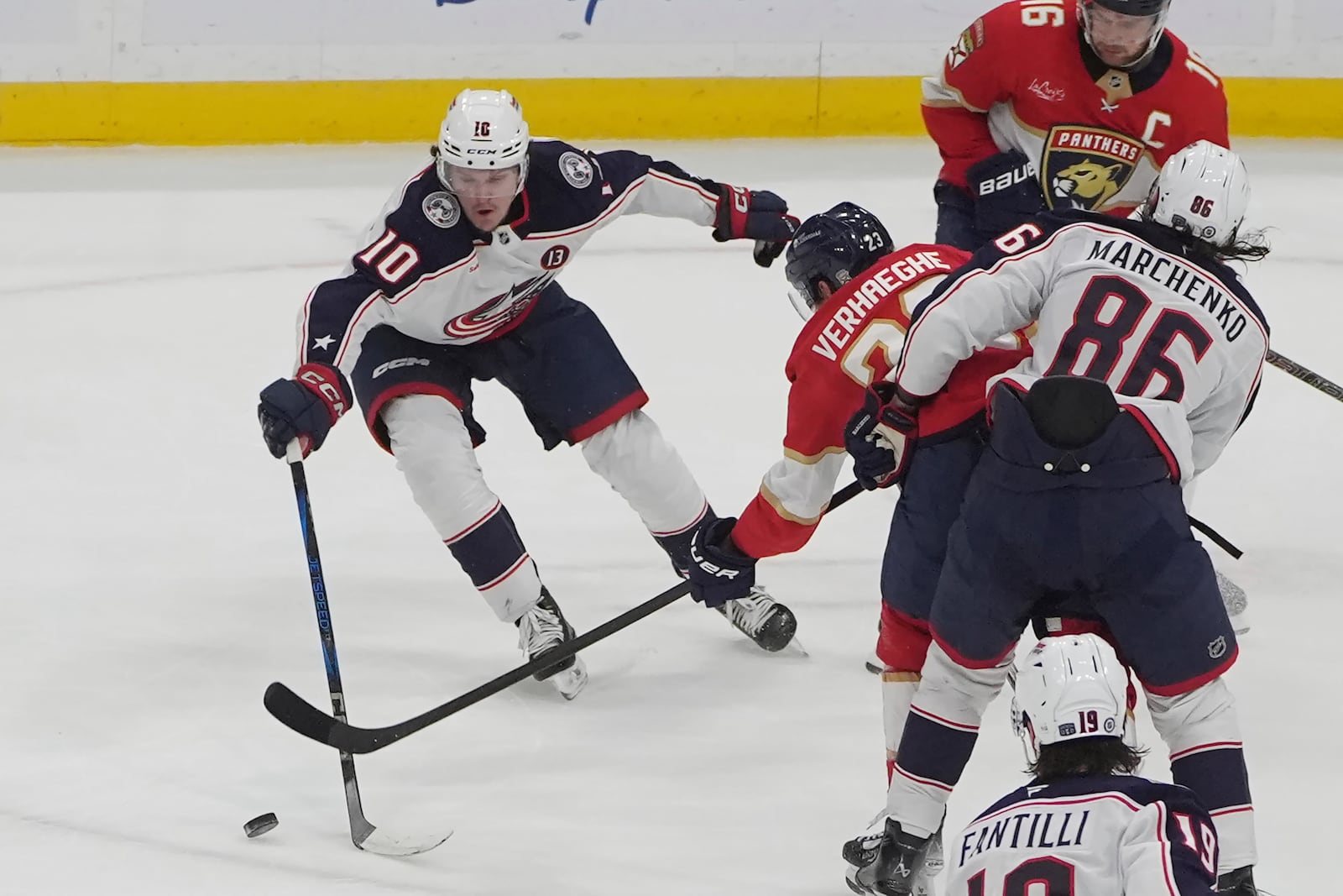 Columbus Blue Jackets left wing Dmitri Voronkov (10) and Florida Panthers center Carter Verhaeghe (23) go after the puck during the second period of an NHL hockey game, Thursday, March 6, 2025, in Sunrise, Fla. (AP Photo/Marta Lavandier)