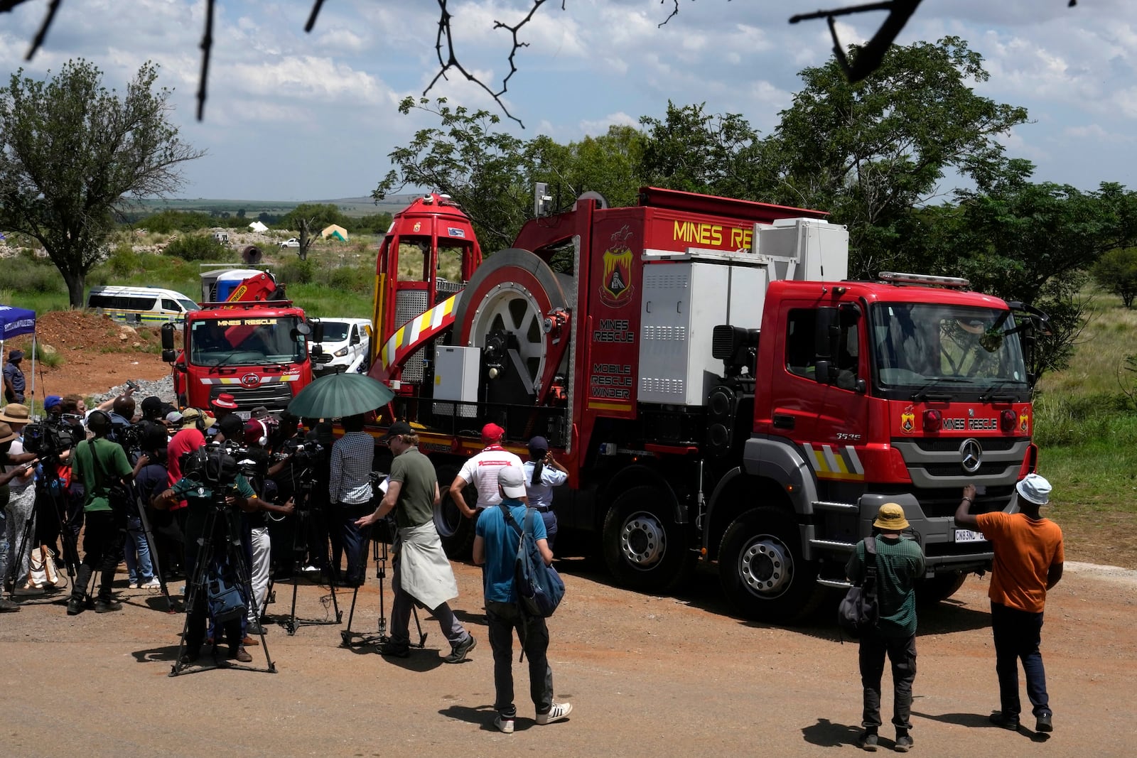 A truck carrying mine rescue workers drives out as they leave after rescueing trapped miners at an abandoned gold mine, where miners were rescued from below ground, in Stilfontein, South Africa, Thursday, Jan. 16, 2025. (AP Photo/Themba Hadebe)