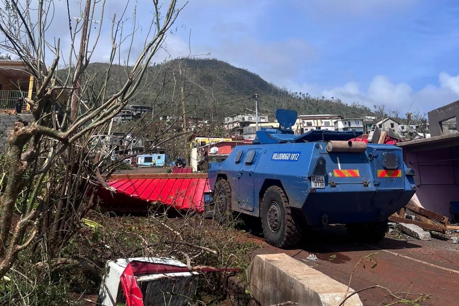 This photo provided Monday, Dec.16, 2024 by the Gendarmerie Nationale shows a vehicle of the Gendarmerie Nationale clearing a road Sunday, Dec. 15, 2024 in Mayotte as France rushed rescue teams and supplies to its largely poor overseas department in the Indian Ocean that has suffered widespread destruction. (Gendarmerie Nationale via AP)