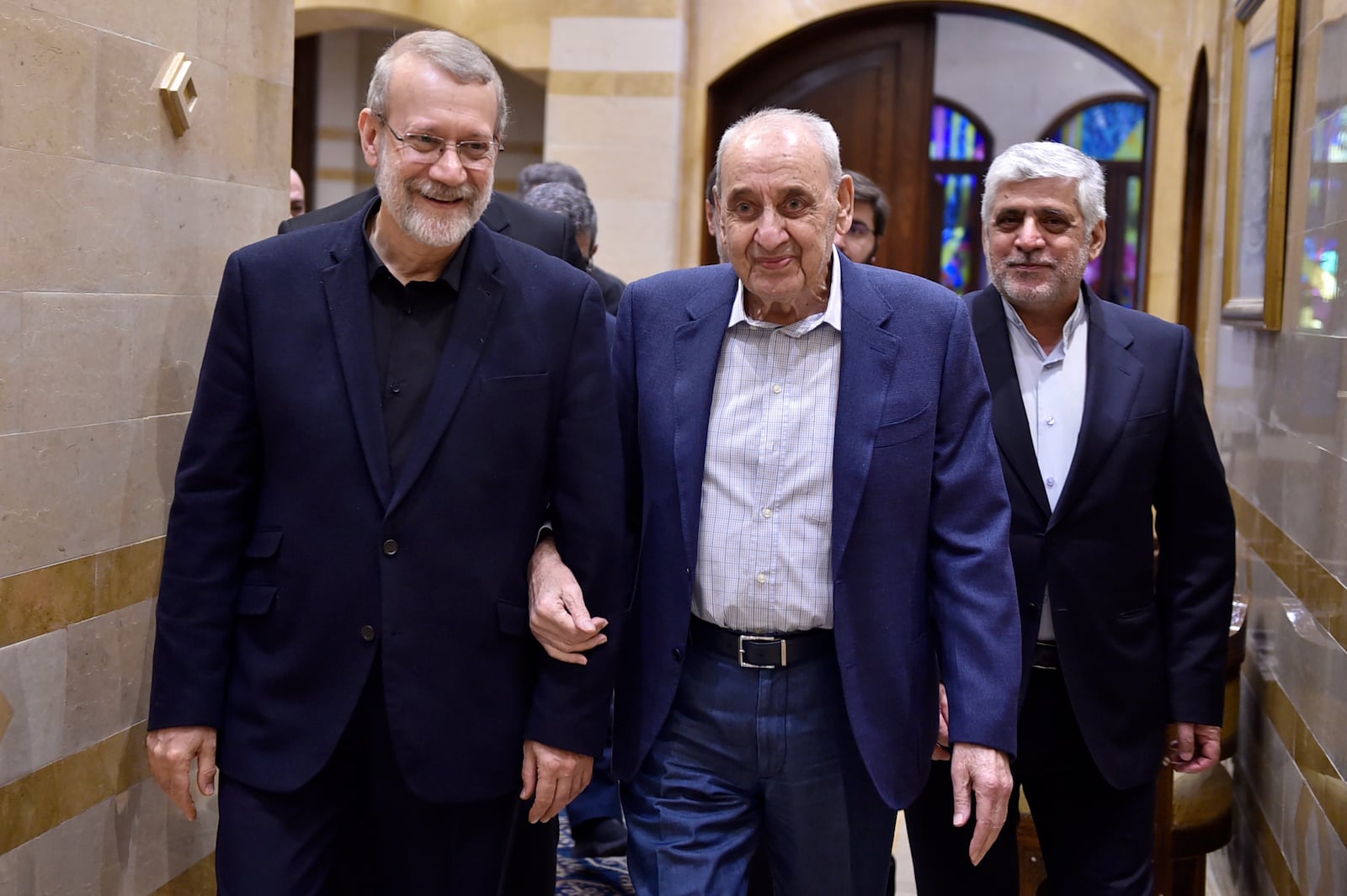 In this photo released by the Lebanese Parliament media office, Lebanese Parliament Speaker Nabih Berri, centre, walks with Ali Larijani, an adviser to Iran's supreme leader Ali Khamenei, in Beirut, Lebanon, Friday, Nov. 15, 2024. (Hassan Ibrahim, Lebanese Parliament media office via AP)