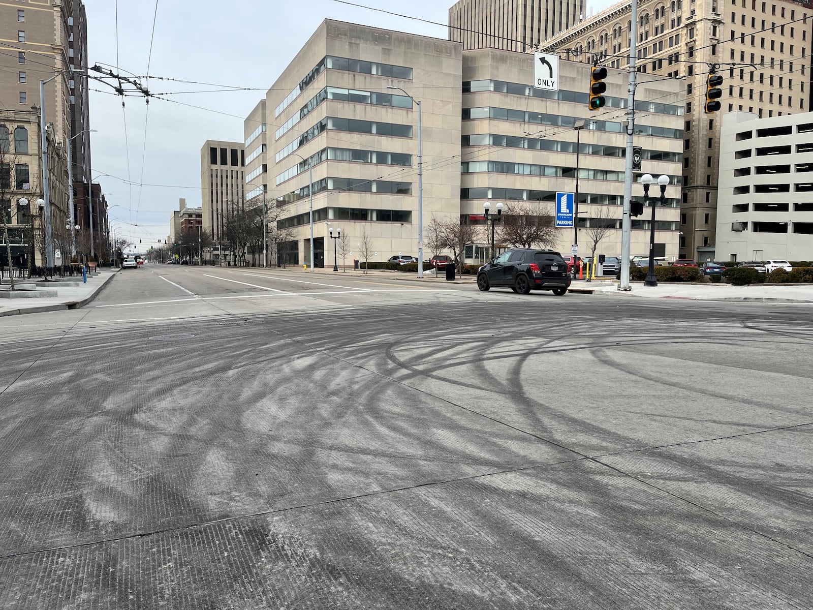 Tire marks at the intersection of East Third and Jefferson streets in downtown Dayton on Monday, Jan. 16, 2023. Multiple vehicles did donuts and drove in circles during a street takeover this past weekend. CORNELIUS FROLIK / STAFF