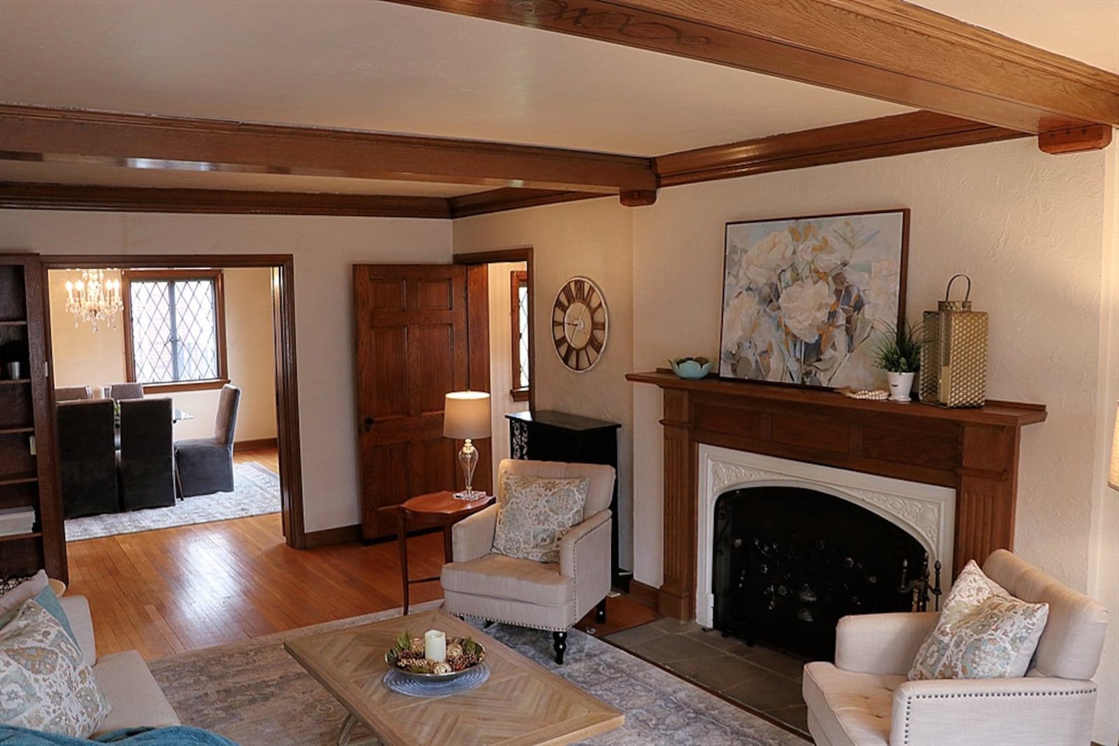 In the living room, the fireplace was converted to gas with a starter and has an ornate wrought-iron screen with flower details. 