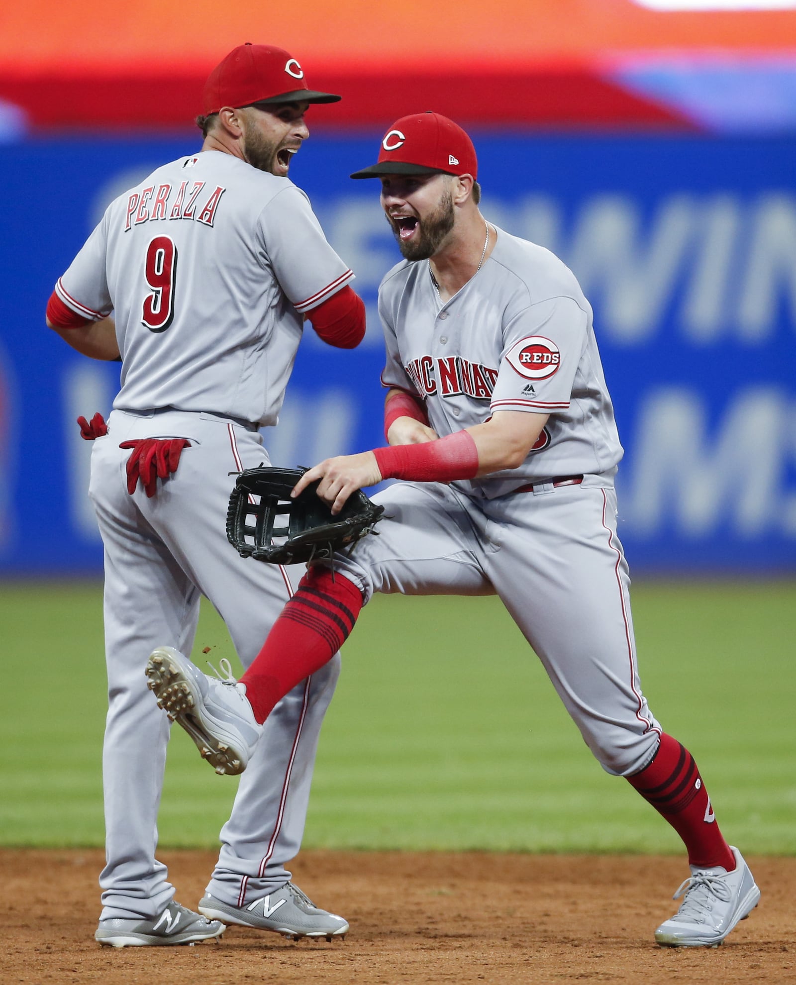 CLEVELAND, OH - JULY 10: Jose Peraza #9 and Jesse Winker #33 of the Cincinnati Reds celebrate a 7-4 victory over the Cleveland Indians at Progressive Field on July 10, 2018 in Cleveland, Ohio. (Photo by Ron Schwane/Getty Images)