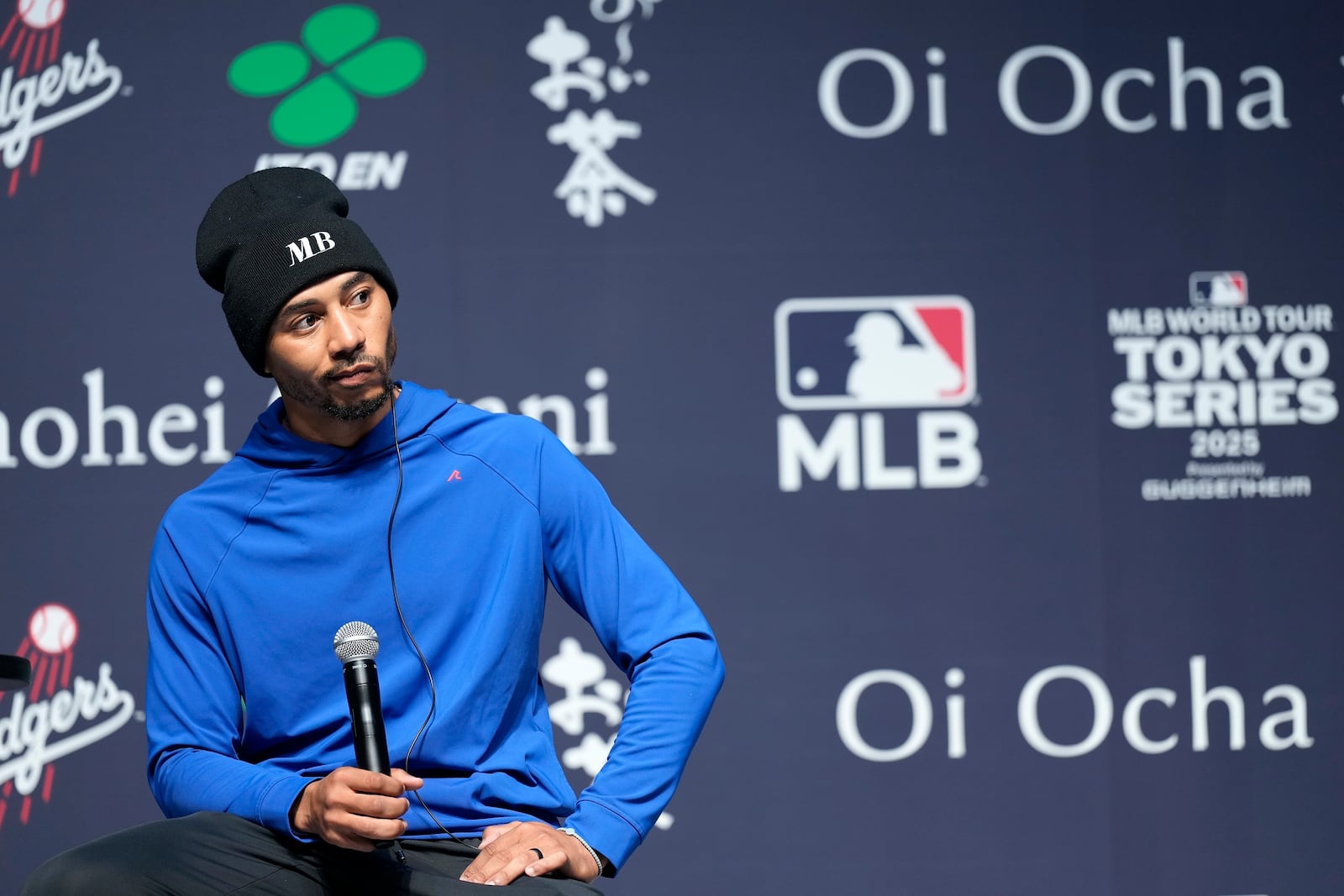 Los Angeles Dodgers right fielder Mookie Betts listens a question from a journalist during a sponsor's promotional event in Tokyo, Tuesday, Jan. 21, 2025. (AP Photo/Eugene Hoshiko)