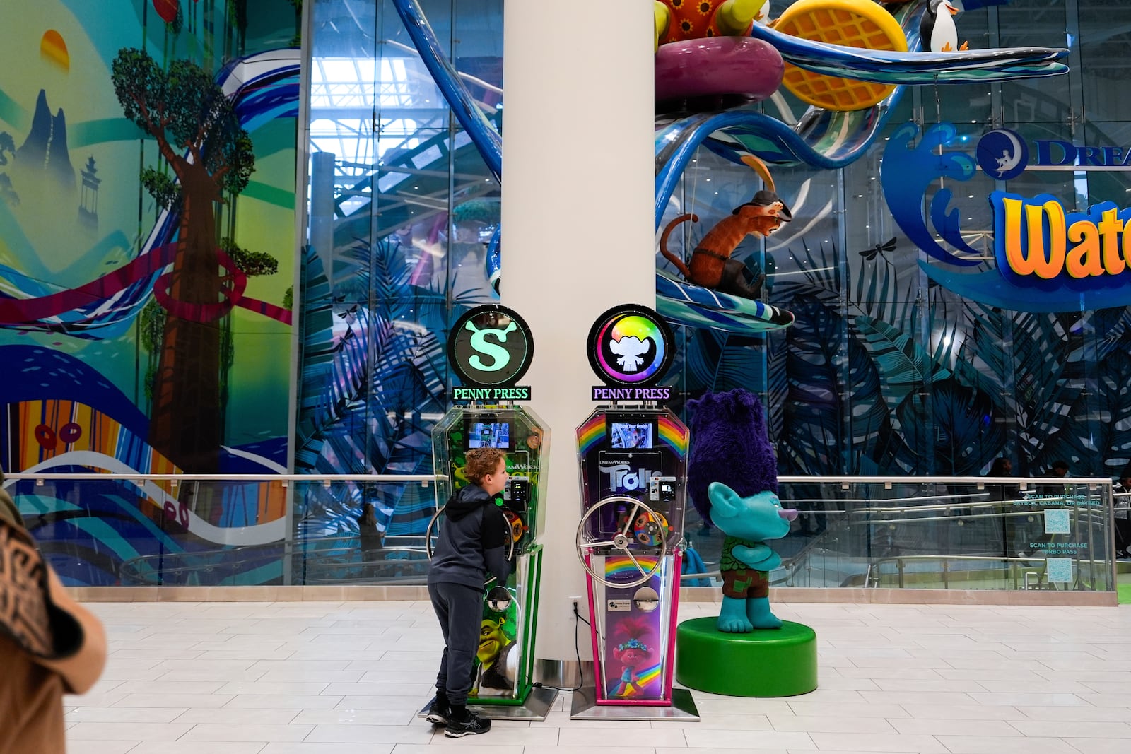 A boy plays with a penny press machine at the American Dream mall, Sunday, March 2, 2025, in East Rutherford, N.J. (AP Photo/Julia Demaree Nikhinson)