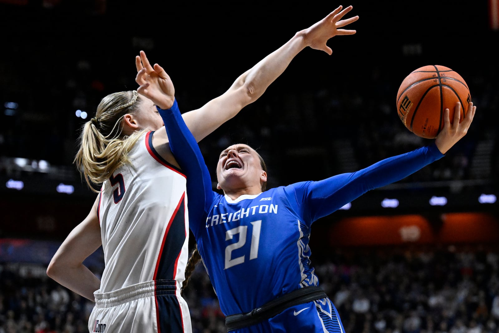 Creighton guard Molly Mogensen (21) shoots as UConn guard Paige Bueckers, left, defends during the first half of an NCAA college basketball game in the finals of the Big East Conference tournament, Monday, March 10, 2025, in Uncasville, Conn. (AP Photo/Jessica Hill)