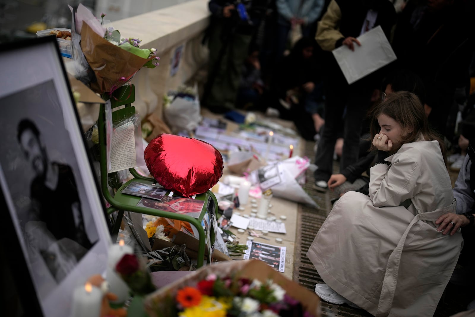 Fans gather to pay tribute to late British singer Liam Payne, former member of the British pop band One Direction, in Paris, France, Sunday, Oct. 20, 2024. (AP Photo/Christophe Ena)